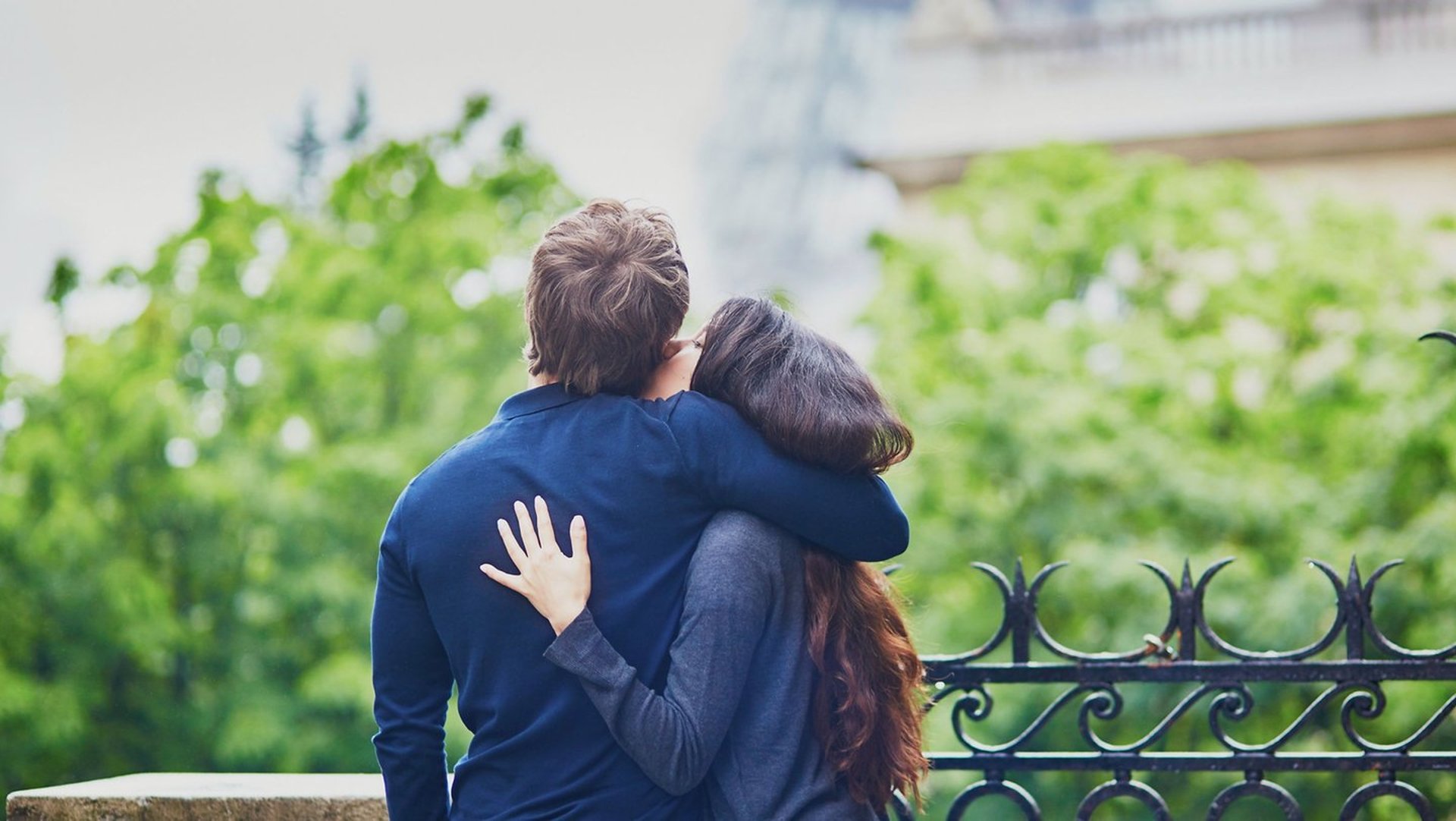 low light photography of vehicle crossing road between high-rise buildings