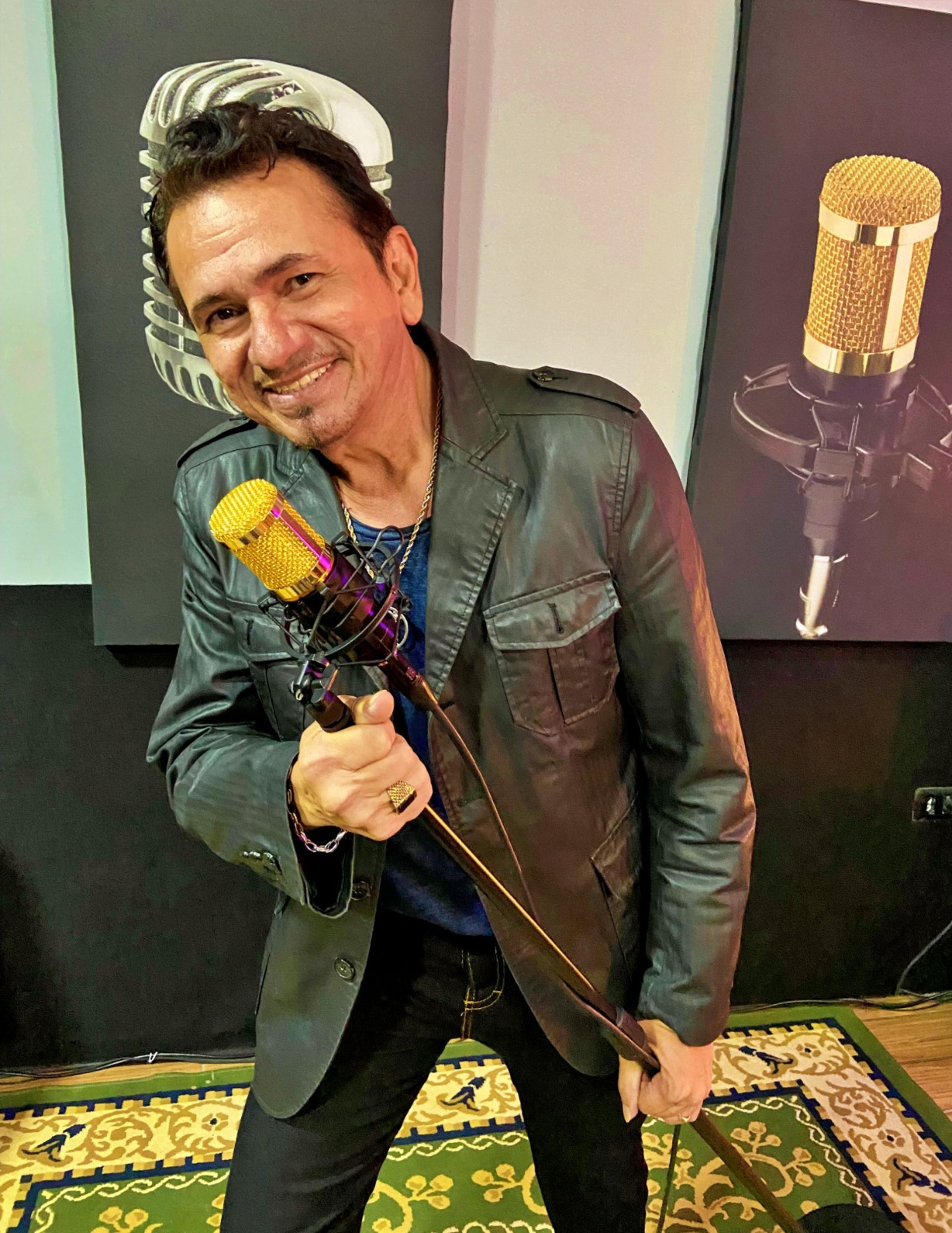 Singer performing on stage with band and lights