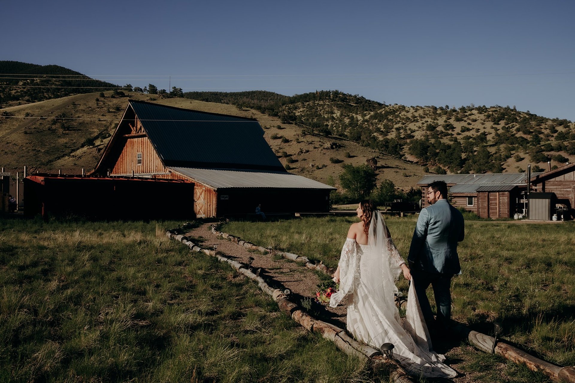 Couple walks towards Steel House Barn