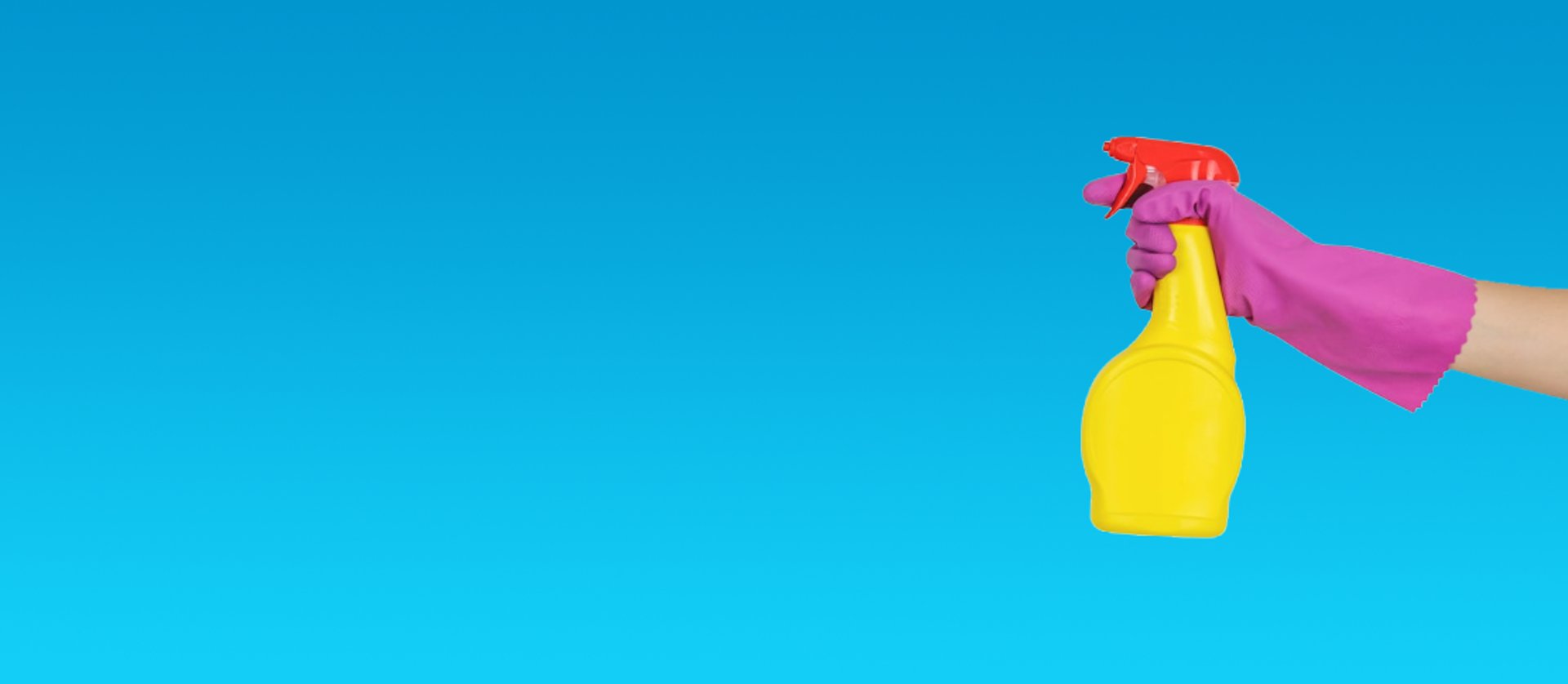 person holding blue textile near clear glass bottle