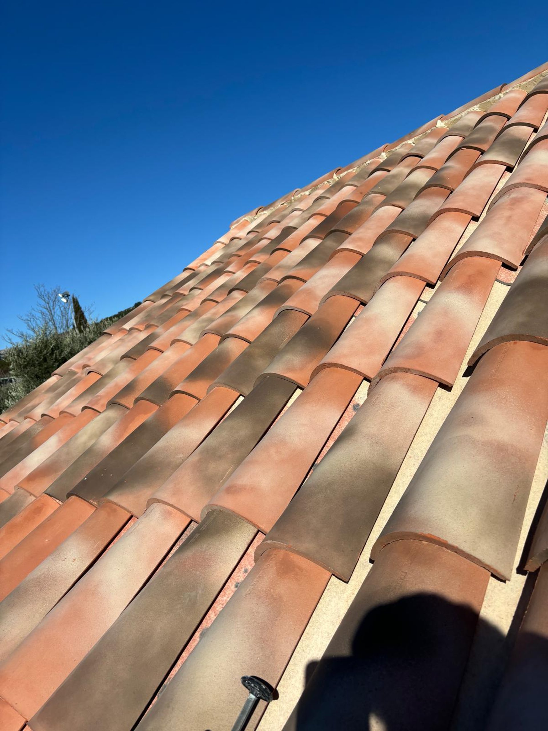 a person wearing blue gloves and holding a hammer