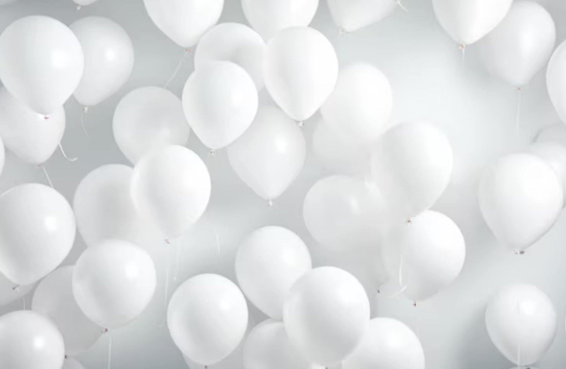 a bucket filled with blue and white balloons