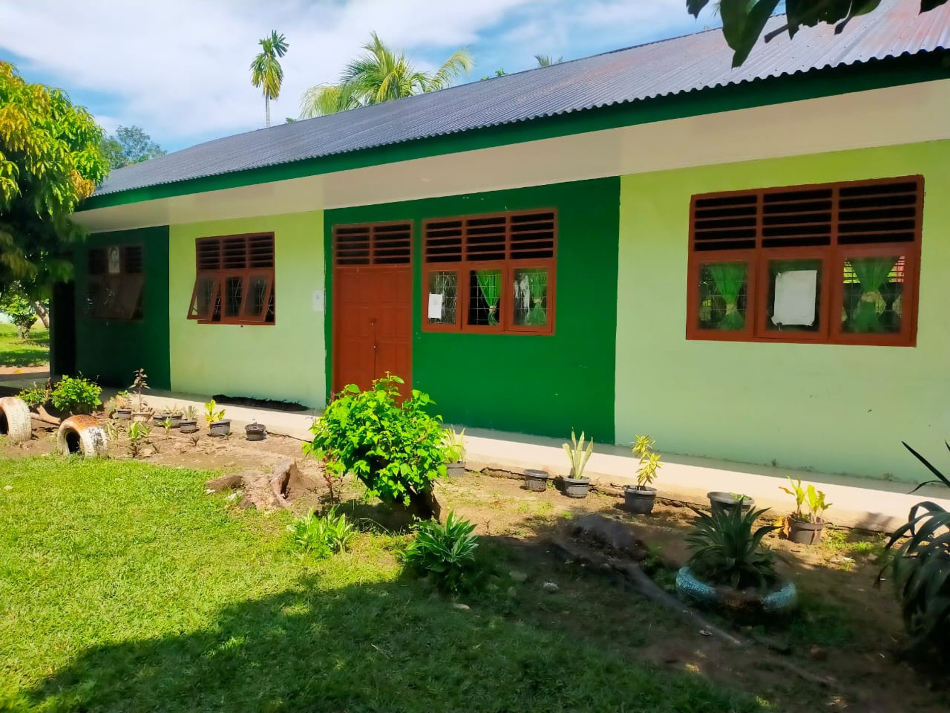 woman wearing yellow long-sleeved dress under white clouds and blue sky during daytime
