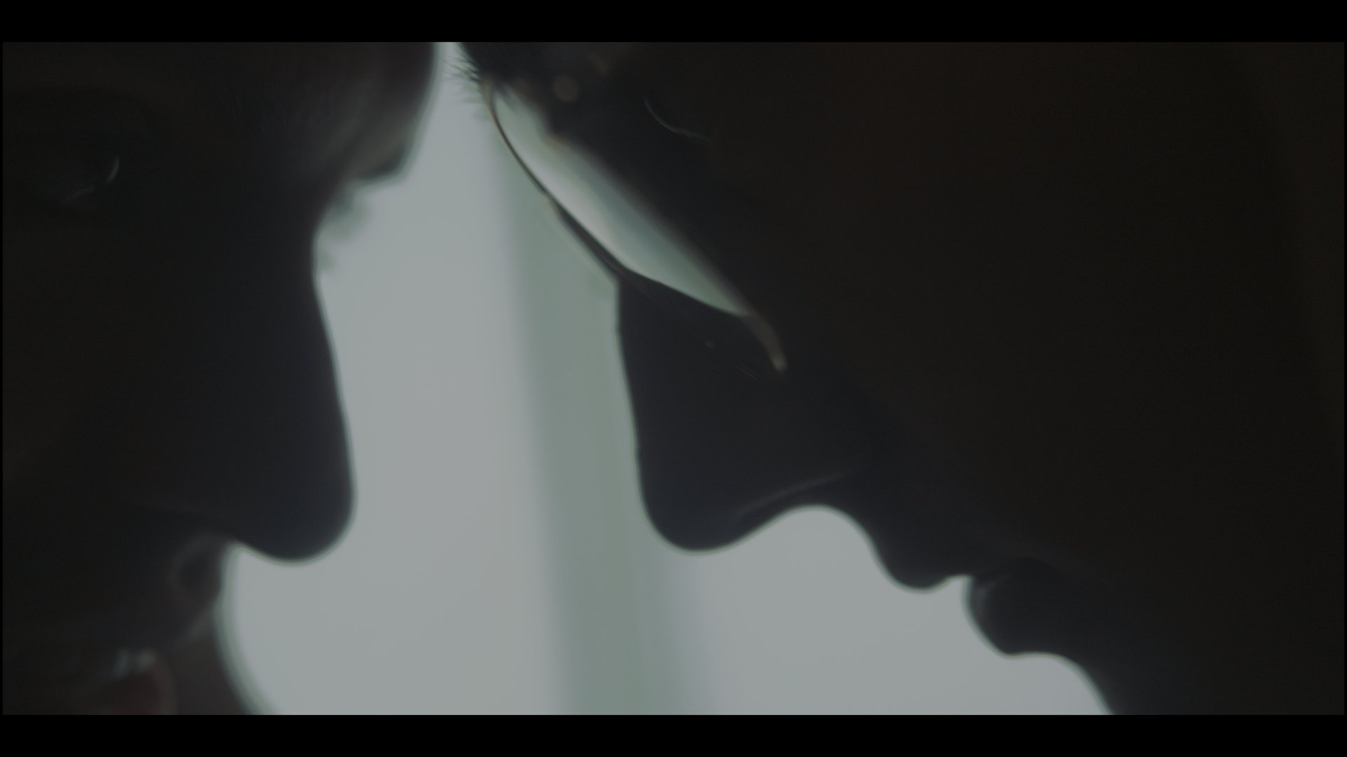 an abstract photo of a curved building with a blue sky in the background