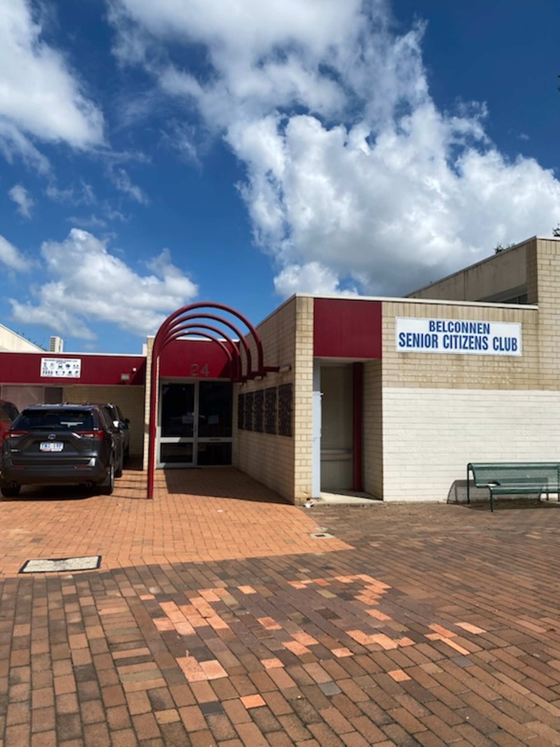 a tall wooden structure sitting on top of a lush green field