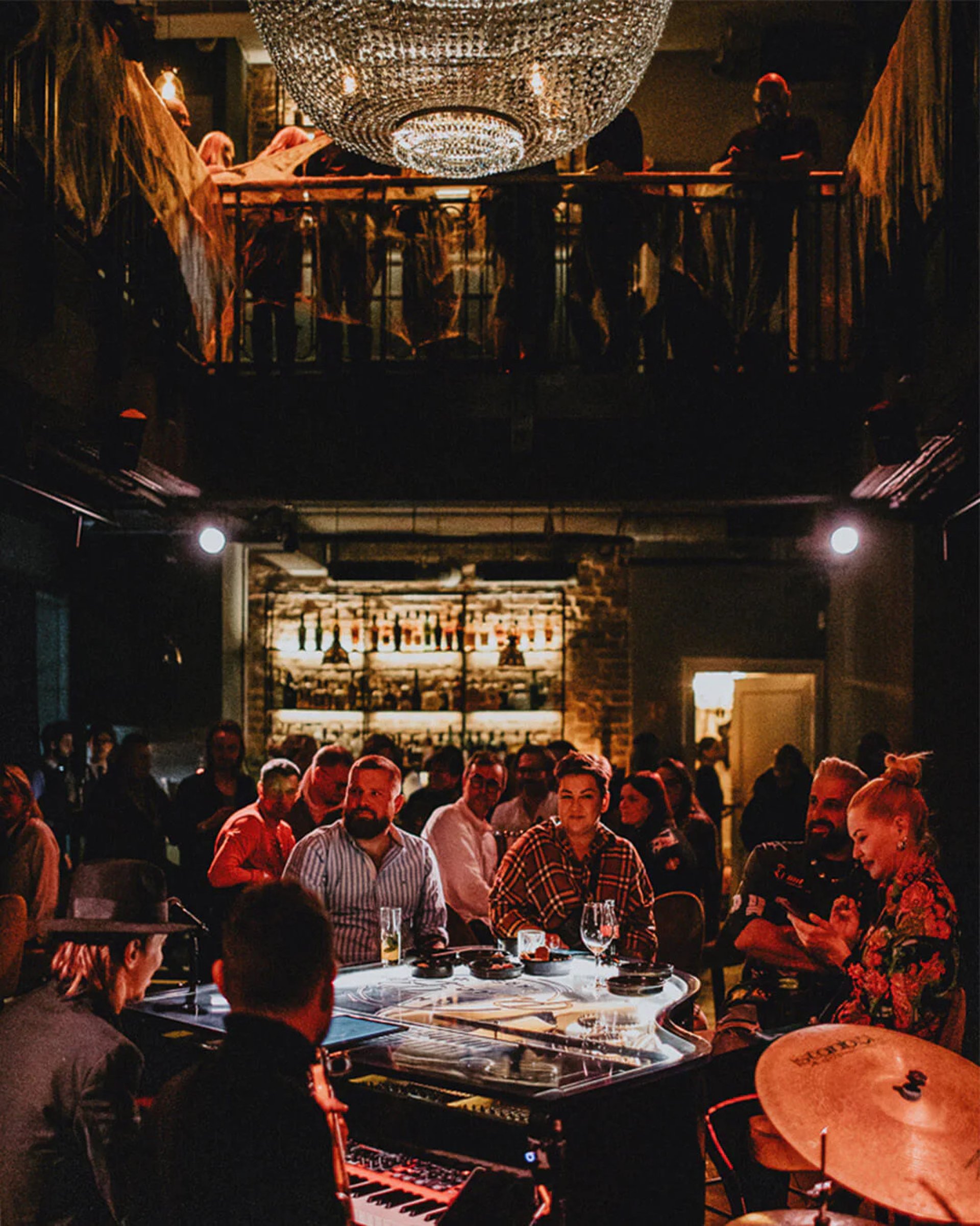 two men in suit sitting on sofa