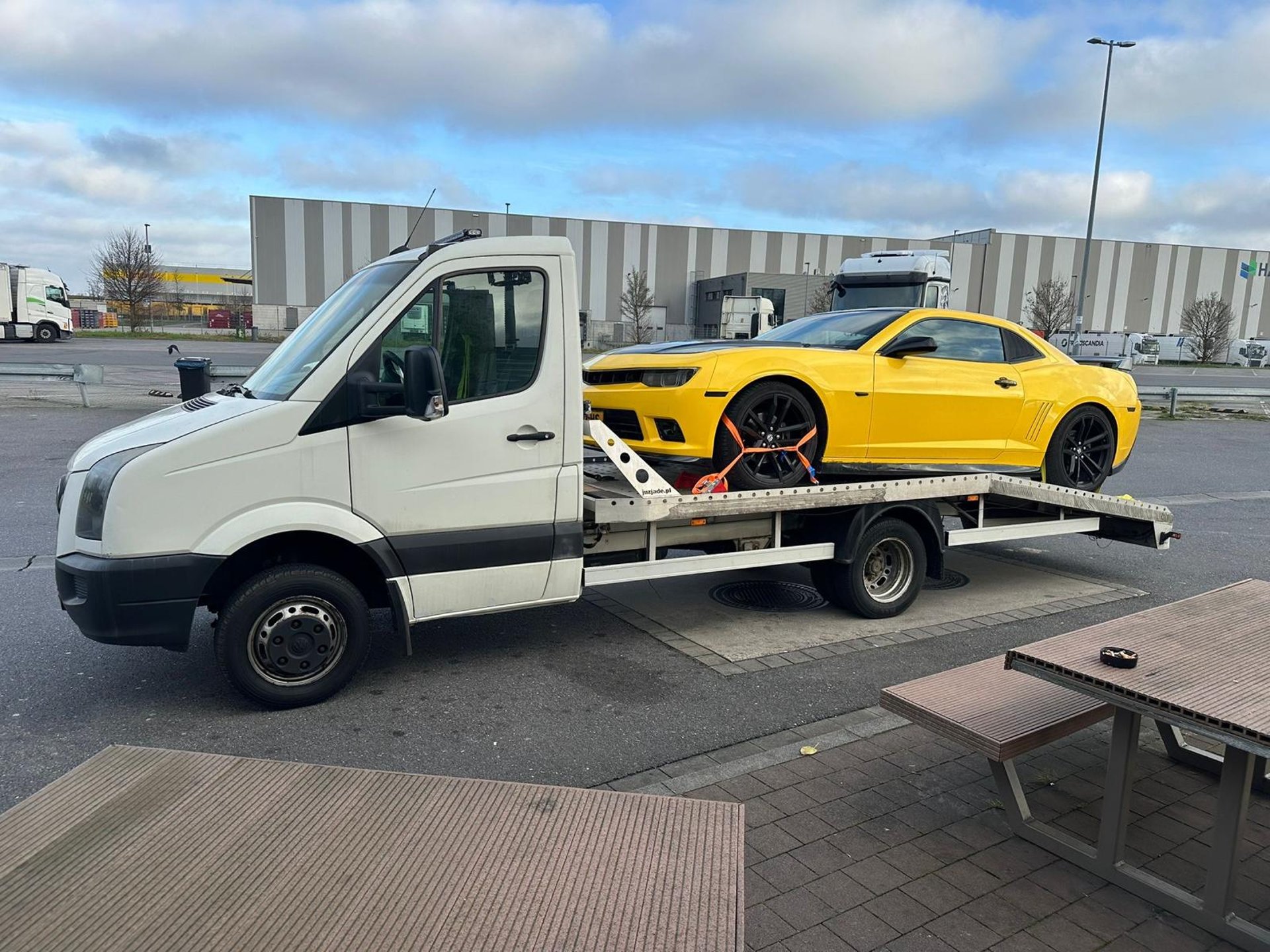a car is being towed on a flatbed trailer