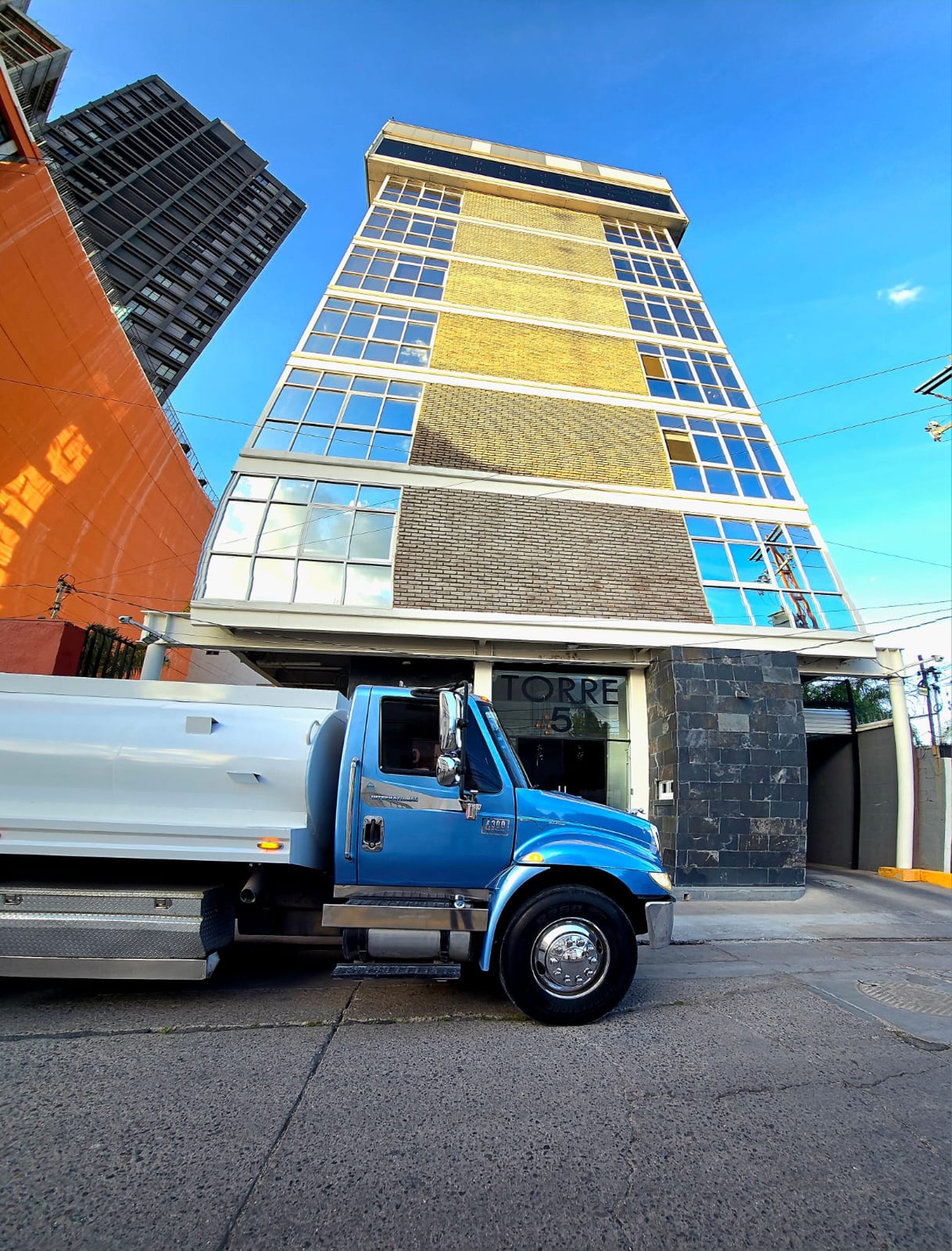 woman wearing yellow long-sleeved dress under white clouds and blue sky during daytime