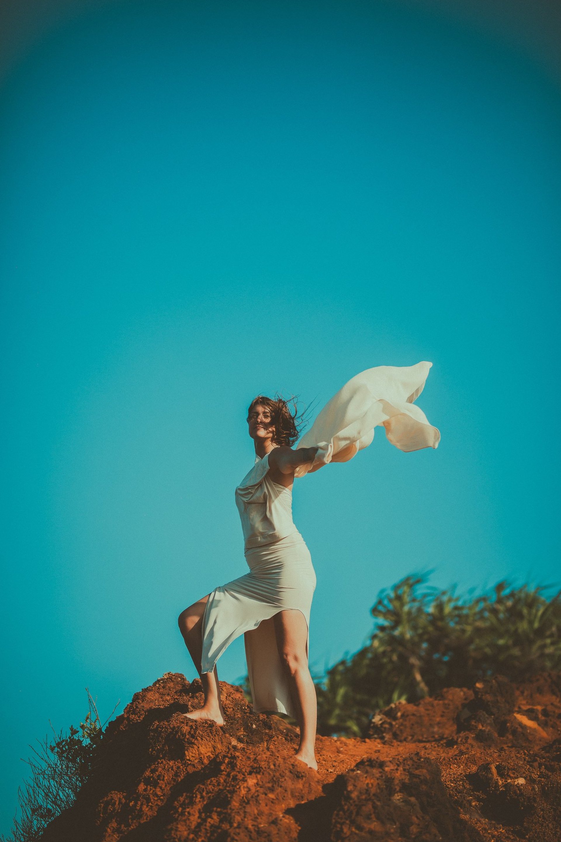 an abstract photo of a curved building with a blue sky in the background