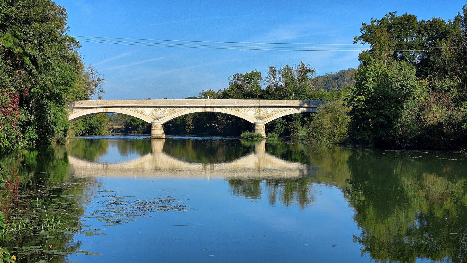 woman wearing yellow long-sleeved dress under white clouds and blue sky during daytime