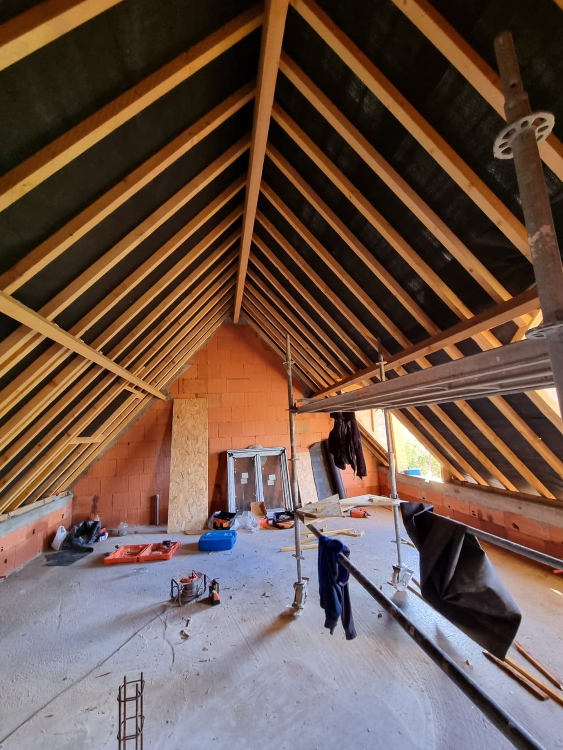 person in blue pants sitting on brown wooden floor