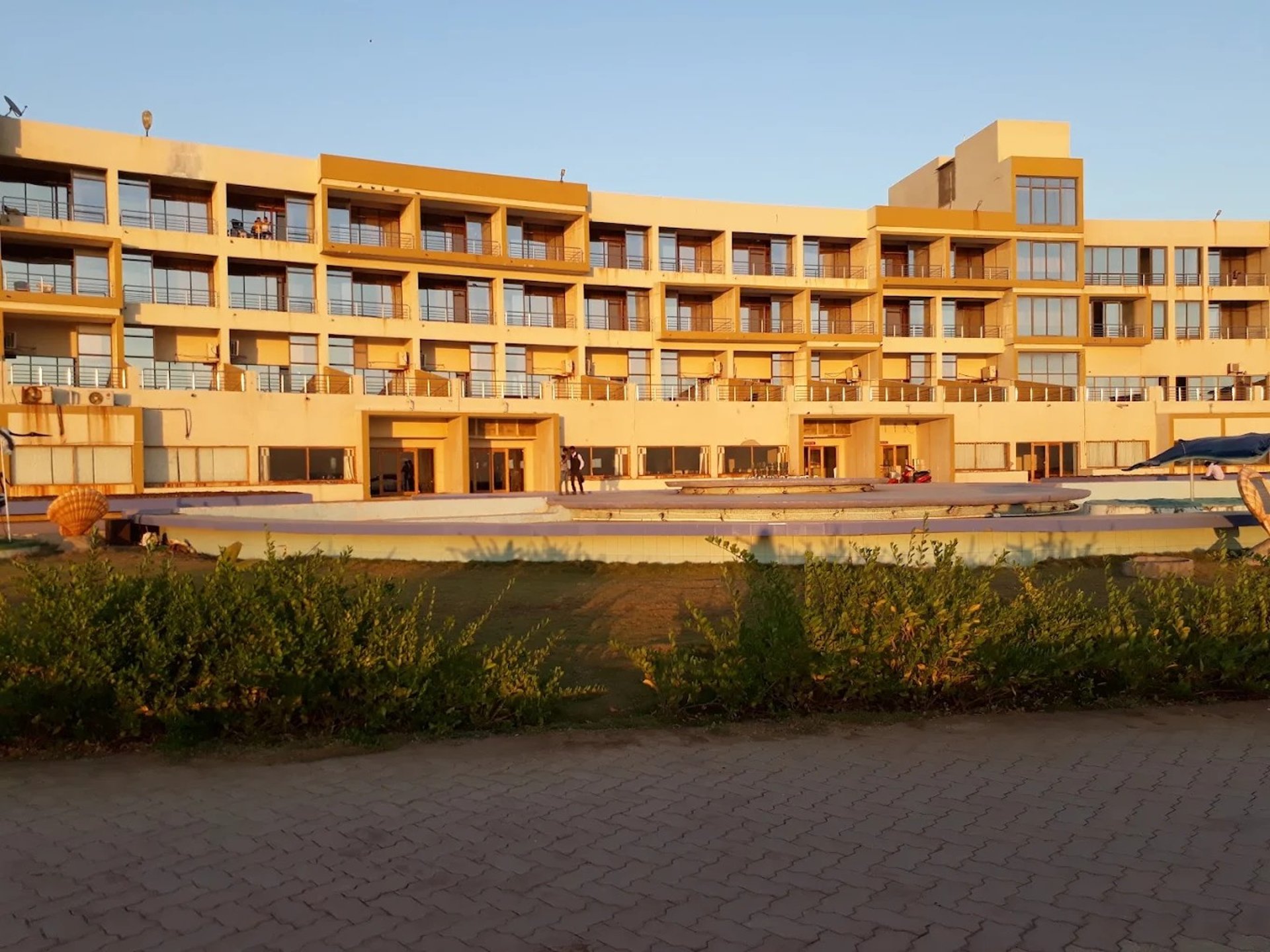 an abstract photo of a curved building with a blue sky in the background