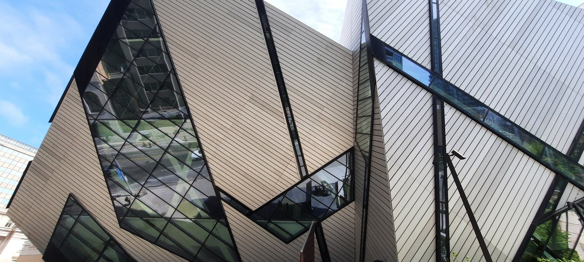 an abstract photo of a curved building with a blue sky in the background