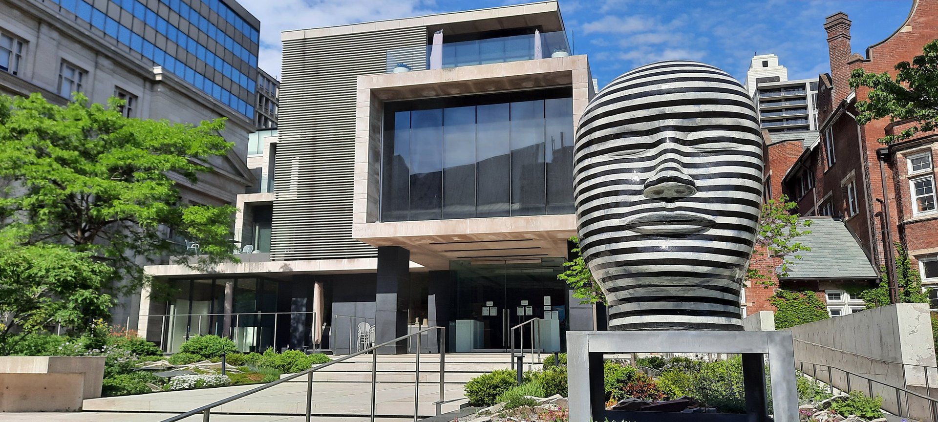 an abstract photo of a curved building with a blue sky in the background