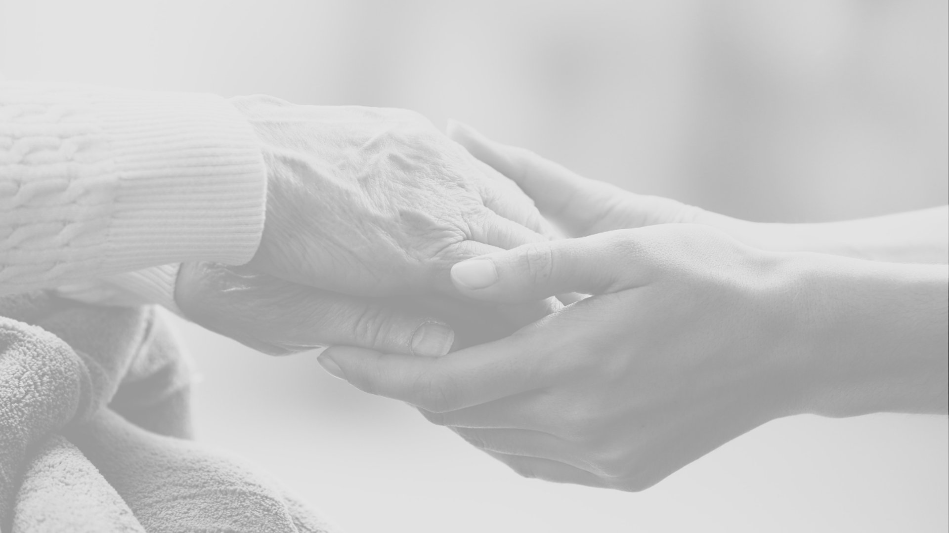 an older woman holding a baby's hand