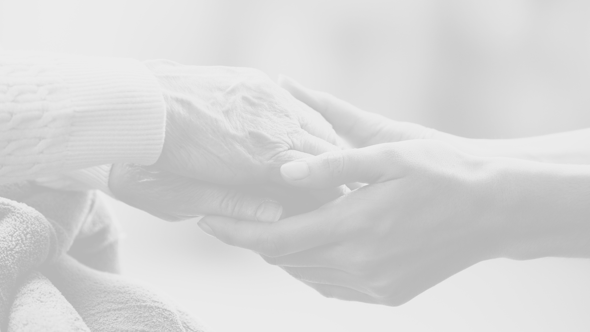 an older woman holding a baby's hand