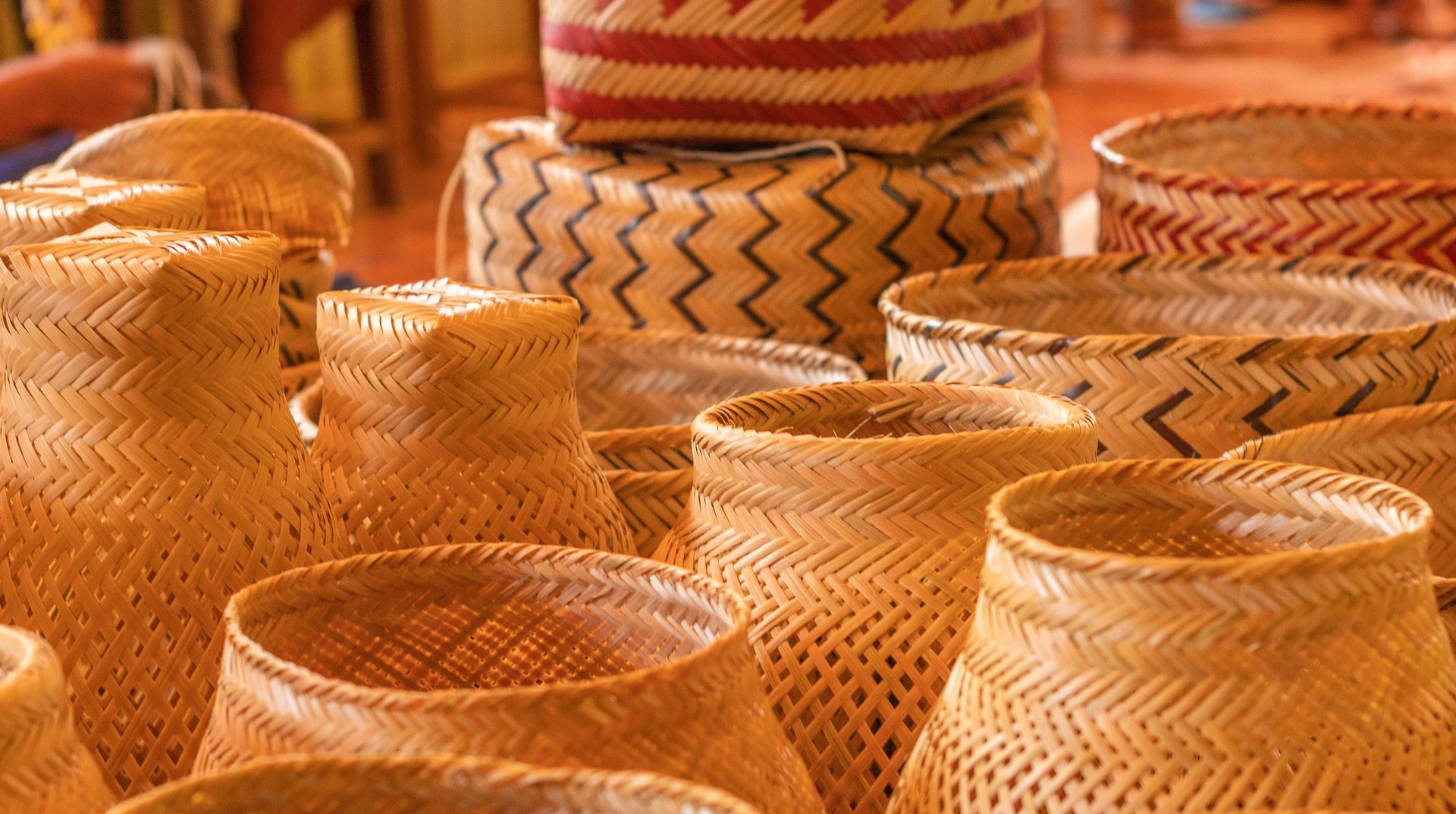 Woven baskets are displayed on a purple table.