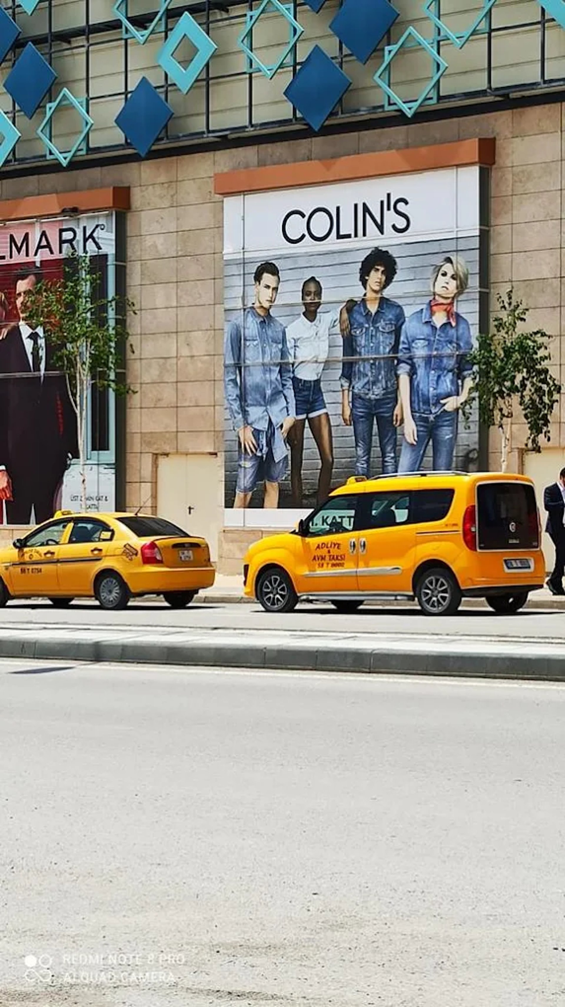 vehicles beside concrete buildings