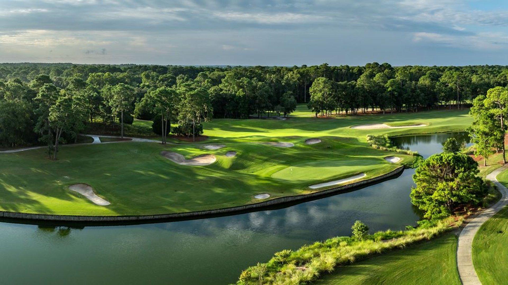 an abstract photo of a curved building with a blue sky in the background