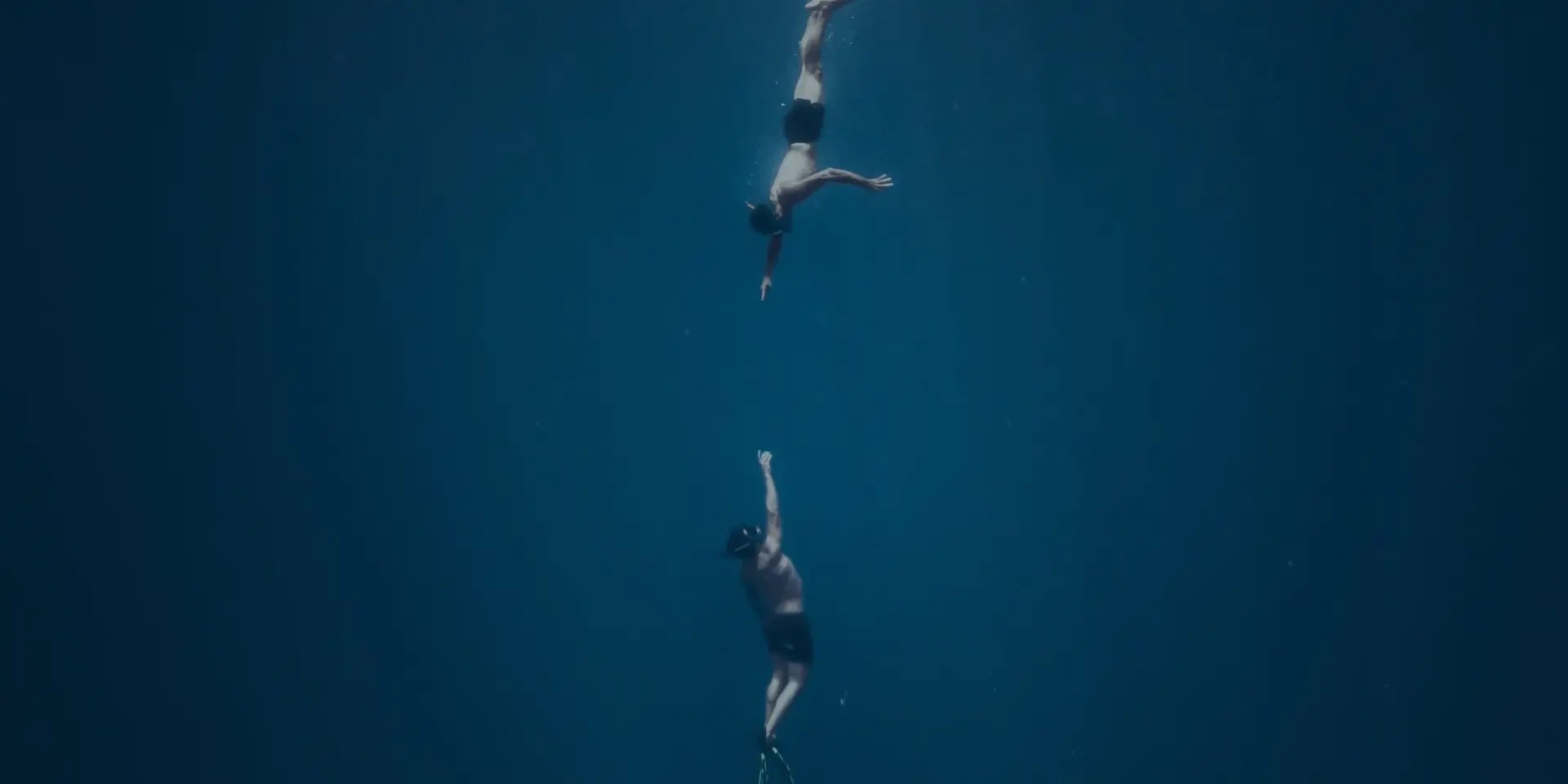 an abstract photo of a curved building with a blue sky in the background