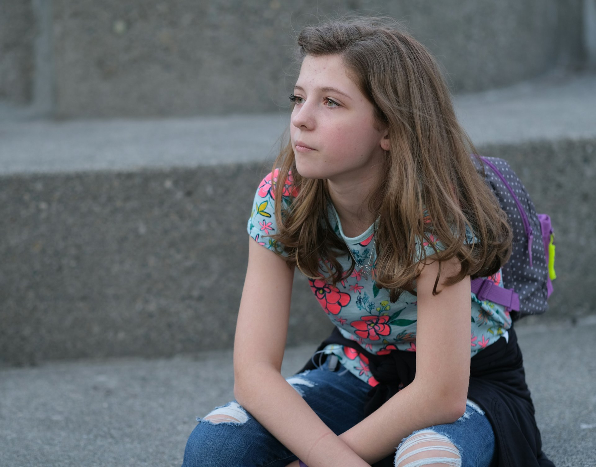 a woman standing in front of a white wall