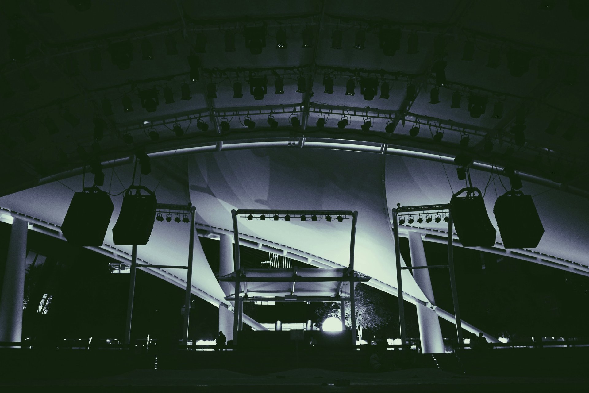 Concert crowd illuminated by bright green stage lights.