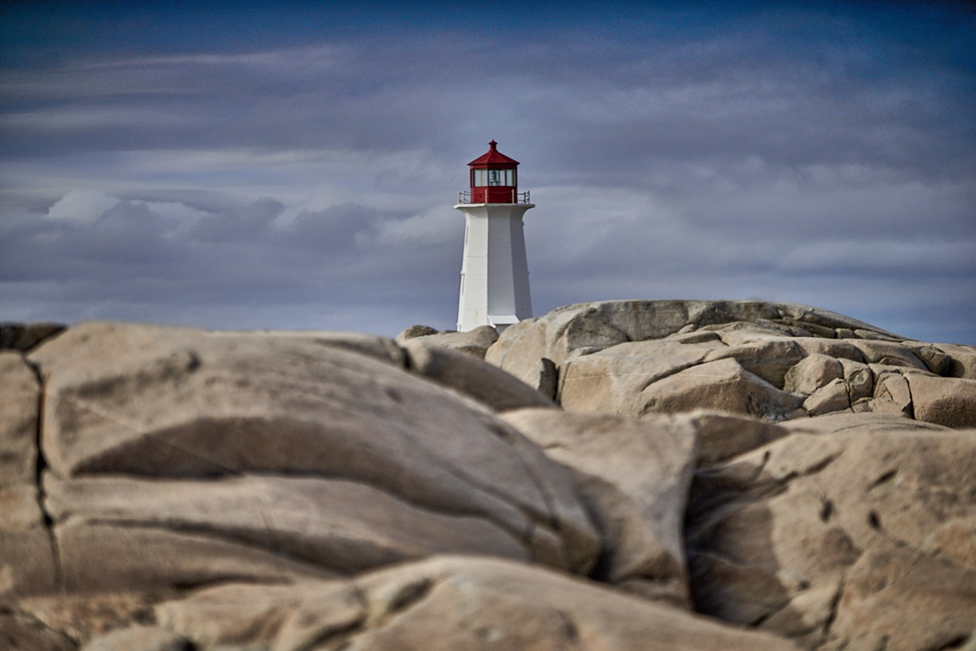 an abstract photo of a curved building with a blue sky in the background