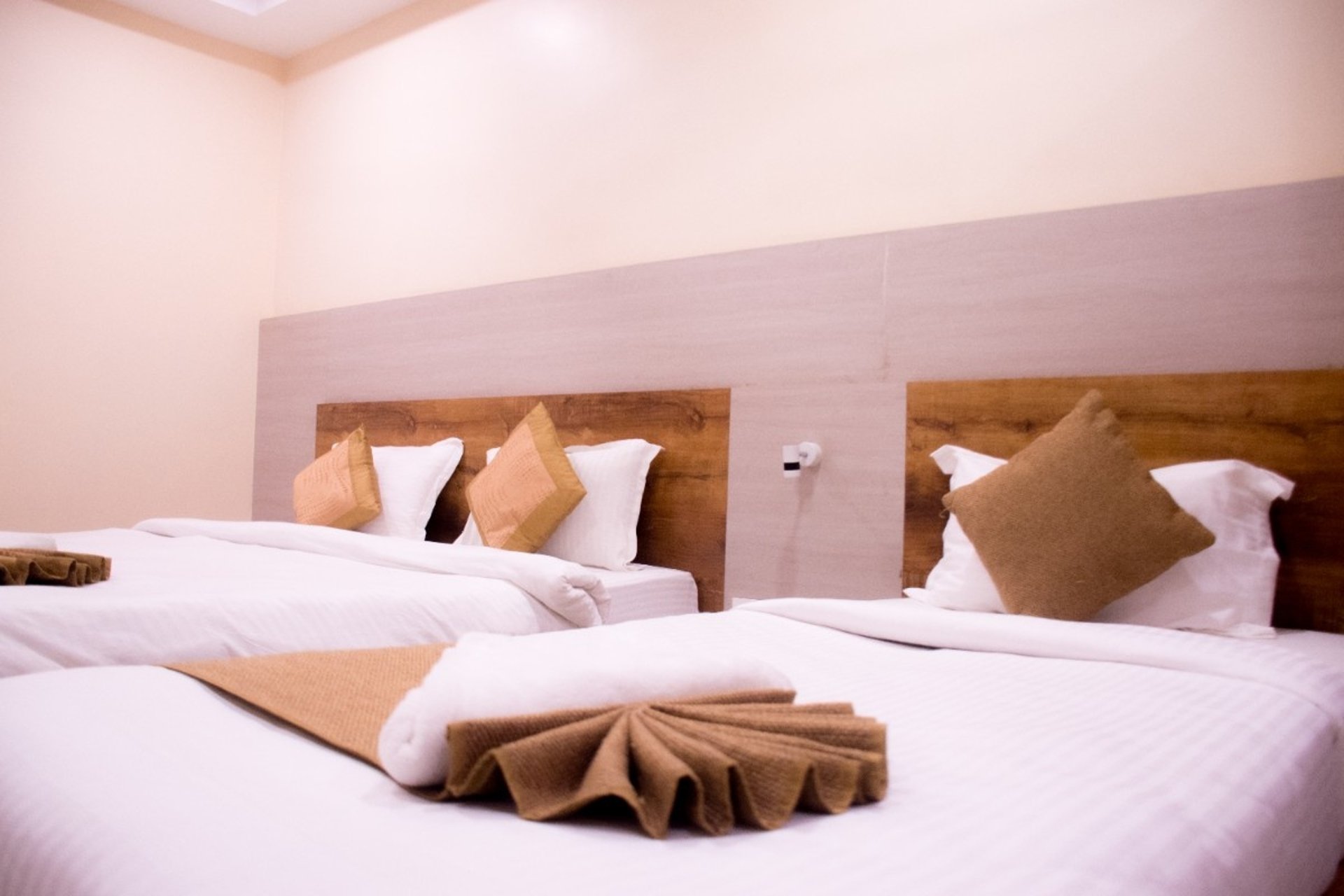 two green and white pillows on empty bed