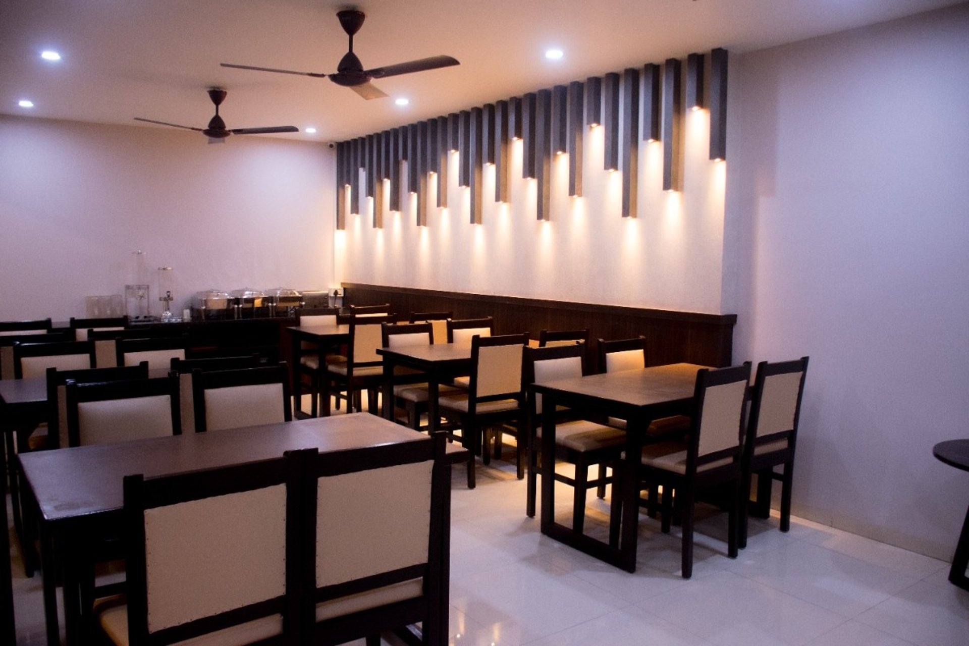 A set dining table in a restaurant with wine glasses.