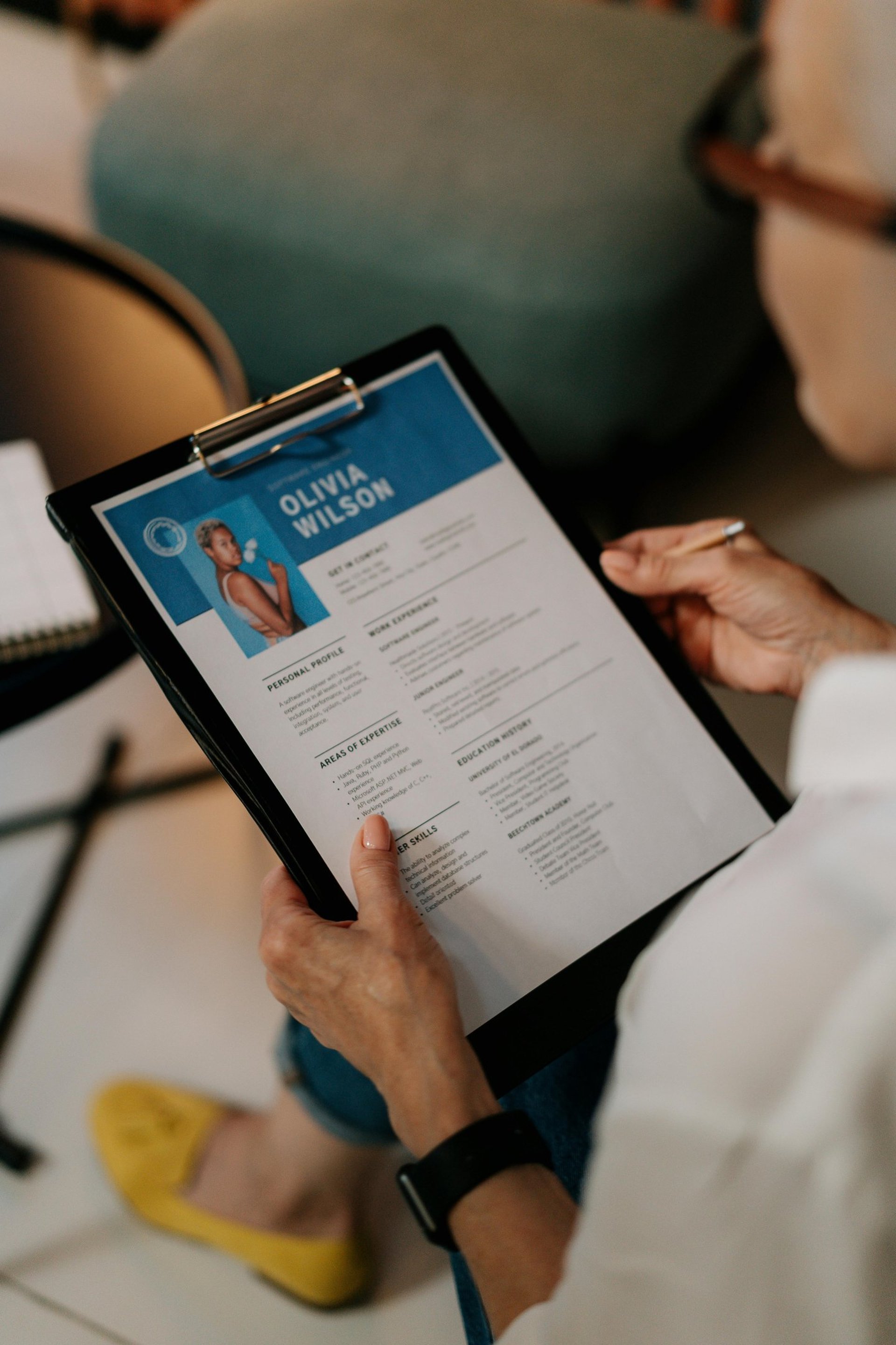 a woman is reading a resume at a table