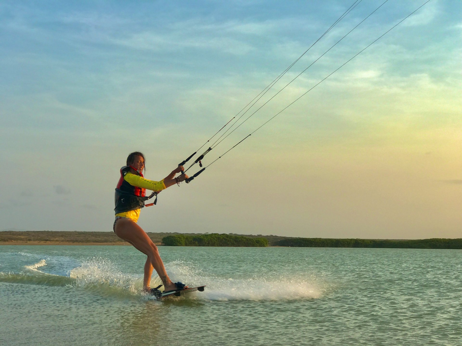 woman wearing yellow long-sleeved dress under white clouds and blue sky during daytime