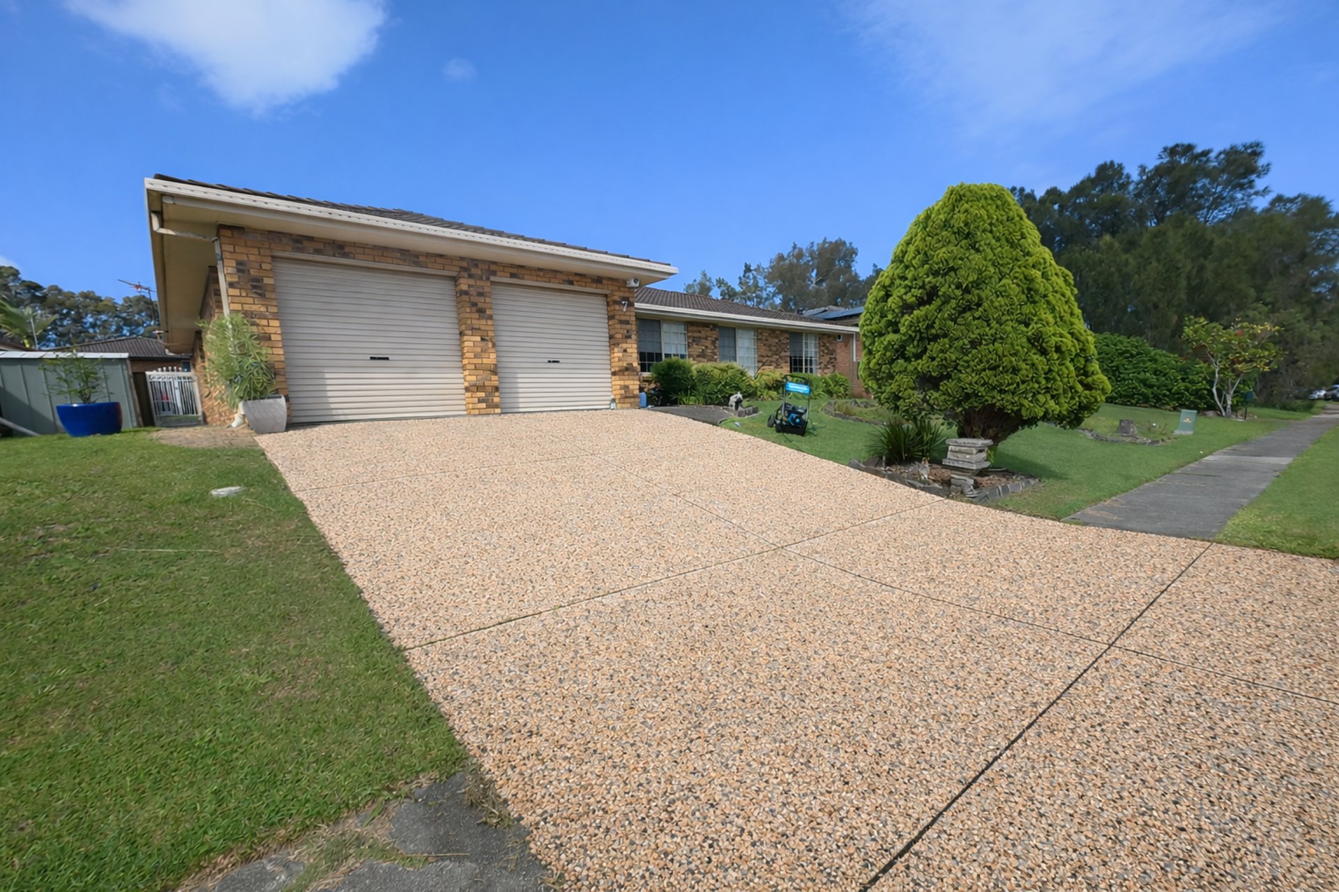 A professionally cleaned concrete pebblecrete driveway in Newcastle near me