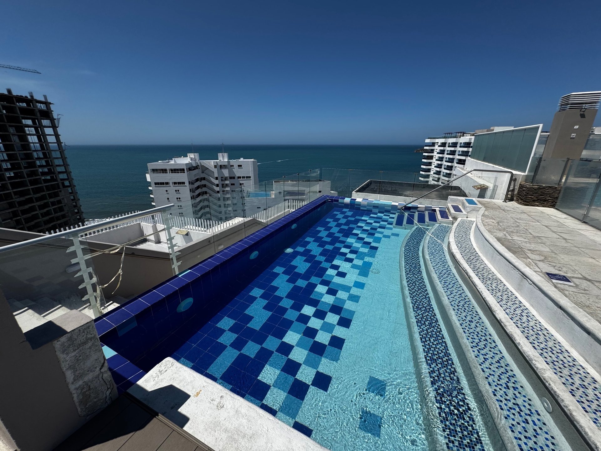 an abstract photo of a curved building with a blue sky in the background