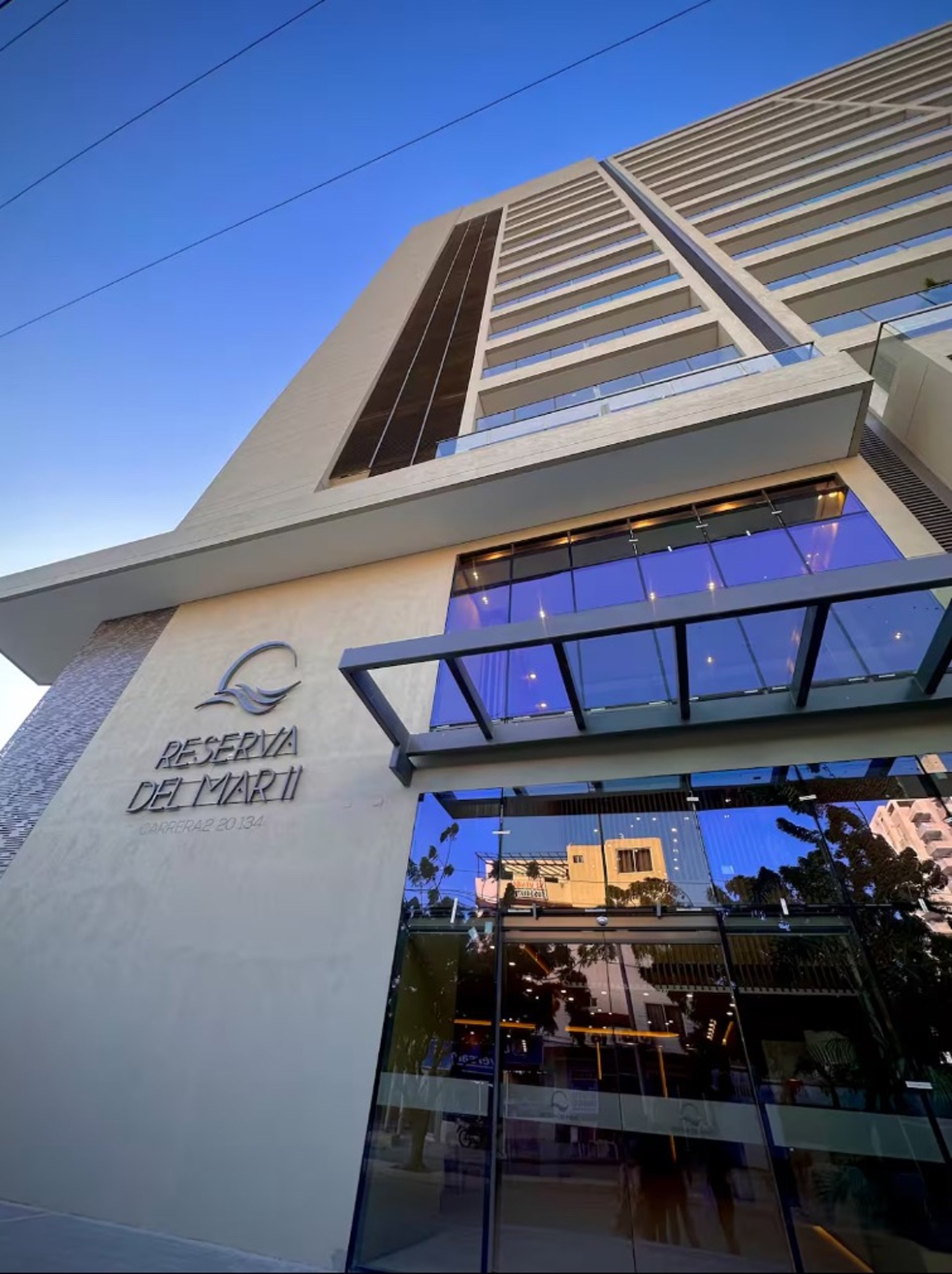 an abstract photo of a curved building with a blue sky in the background