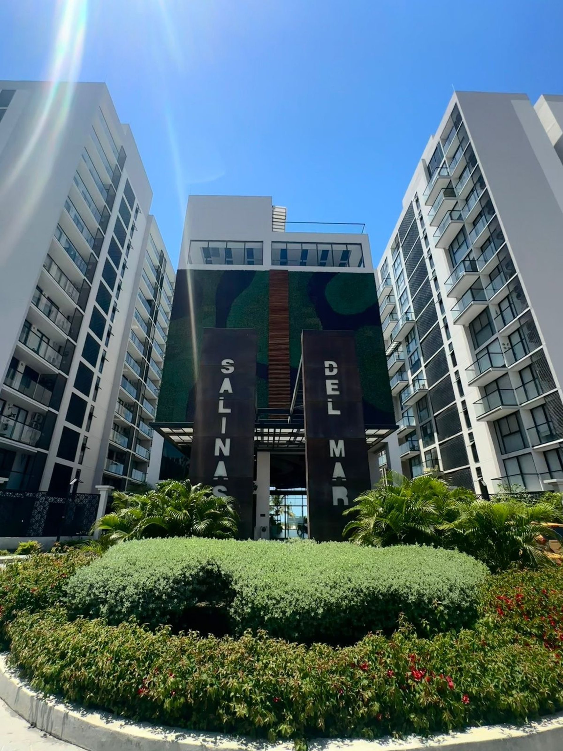 an abstract photo of a curved building with a blue sky in the background