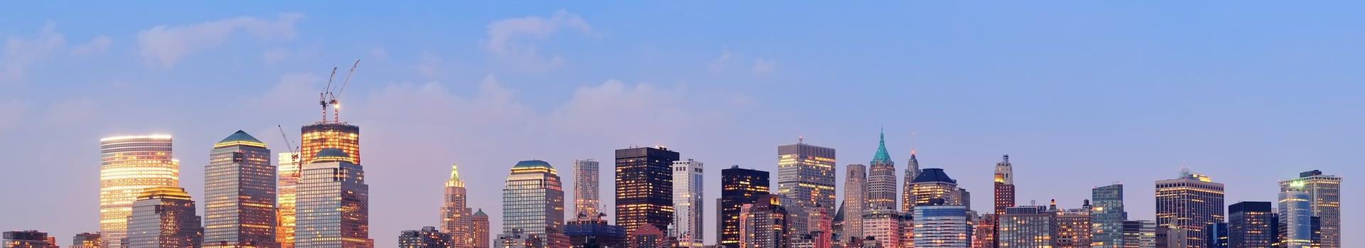 city skyline under white clouds during daytime