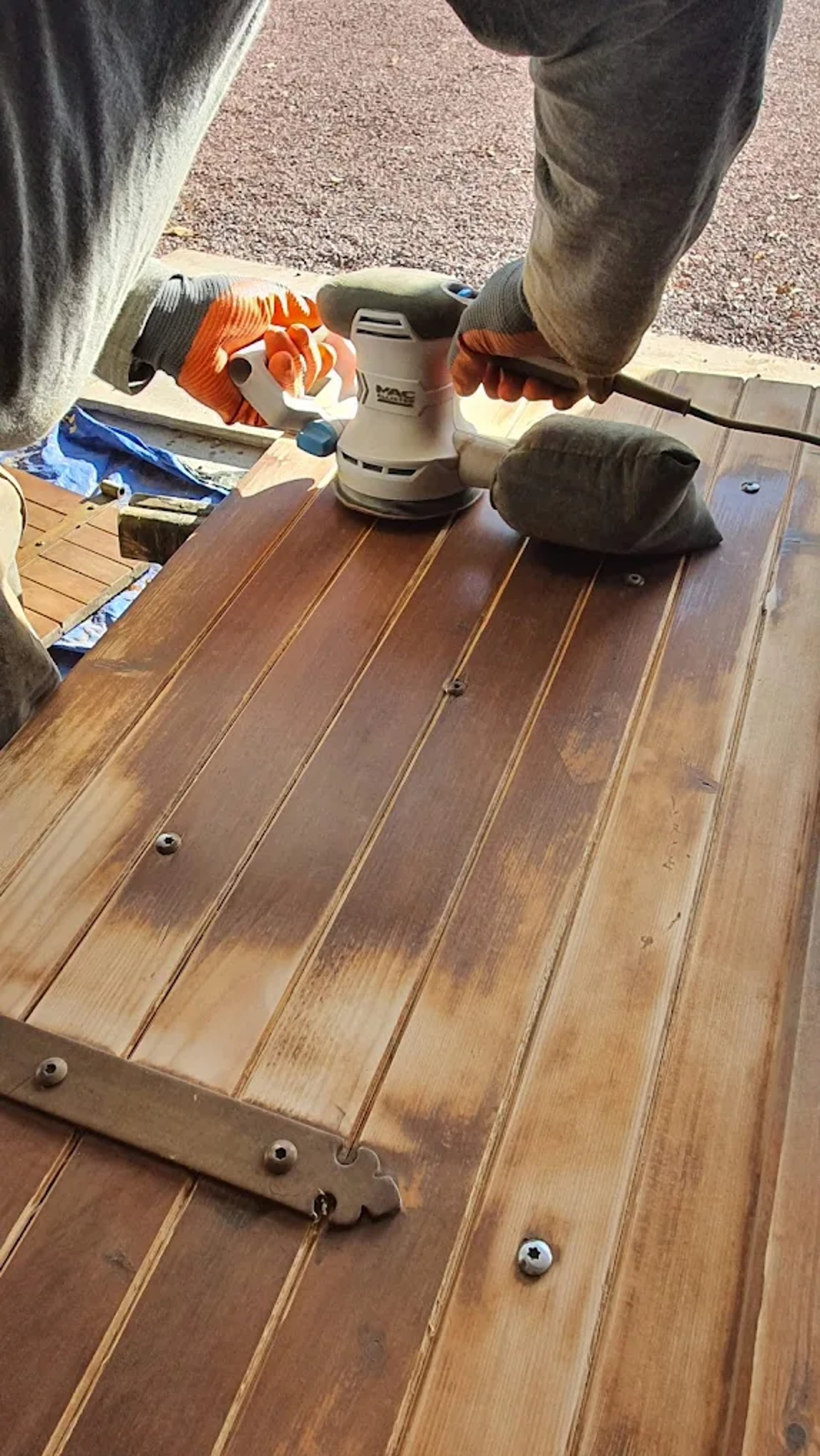 person in blue pants sitting on brown wooden floor