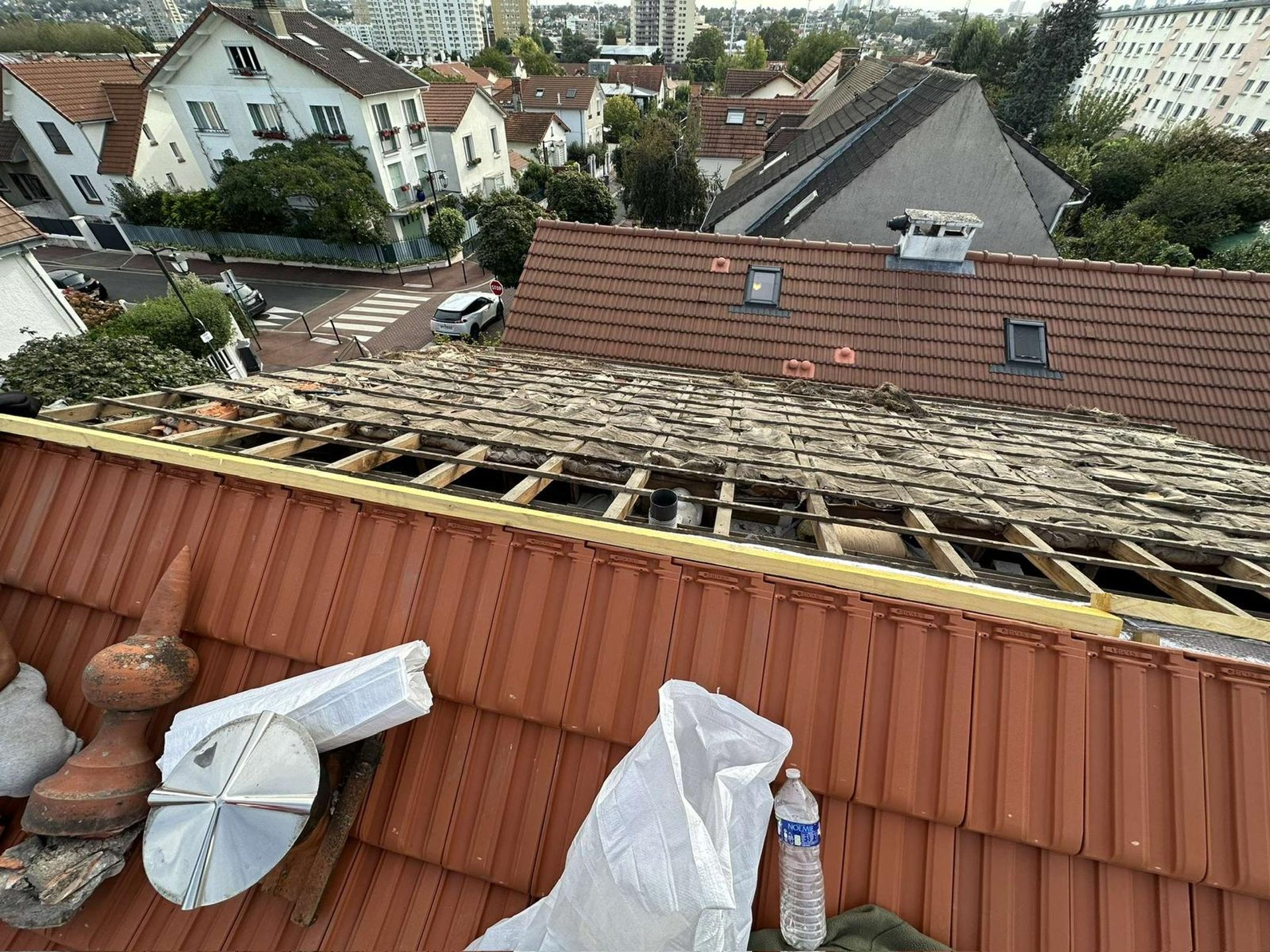 a person wearing blue gloves and holding a hammer