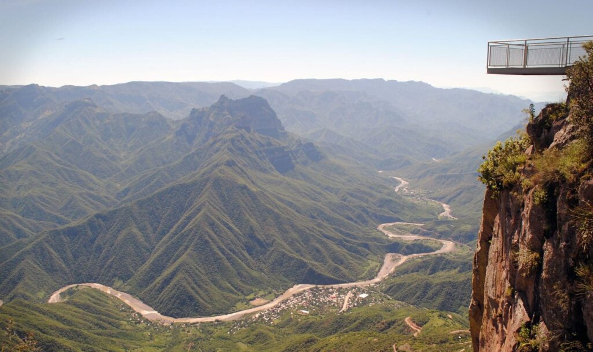 brown wooden house on body of water under blue sky during daytime