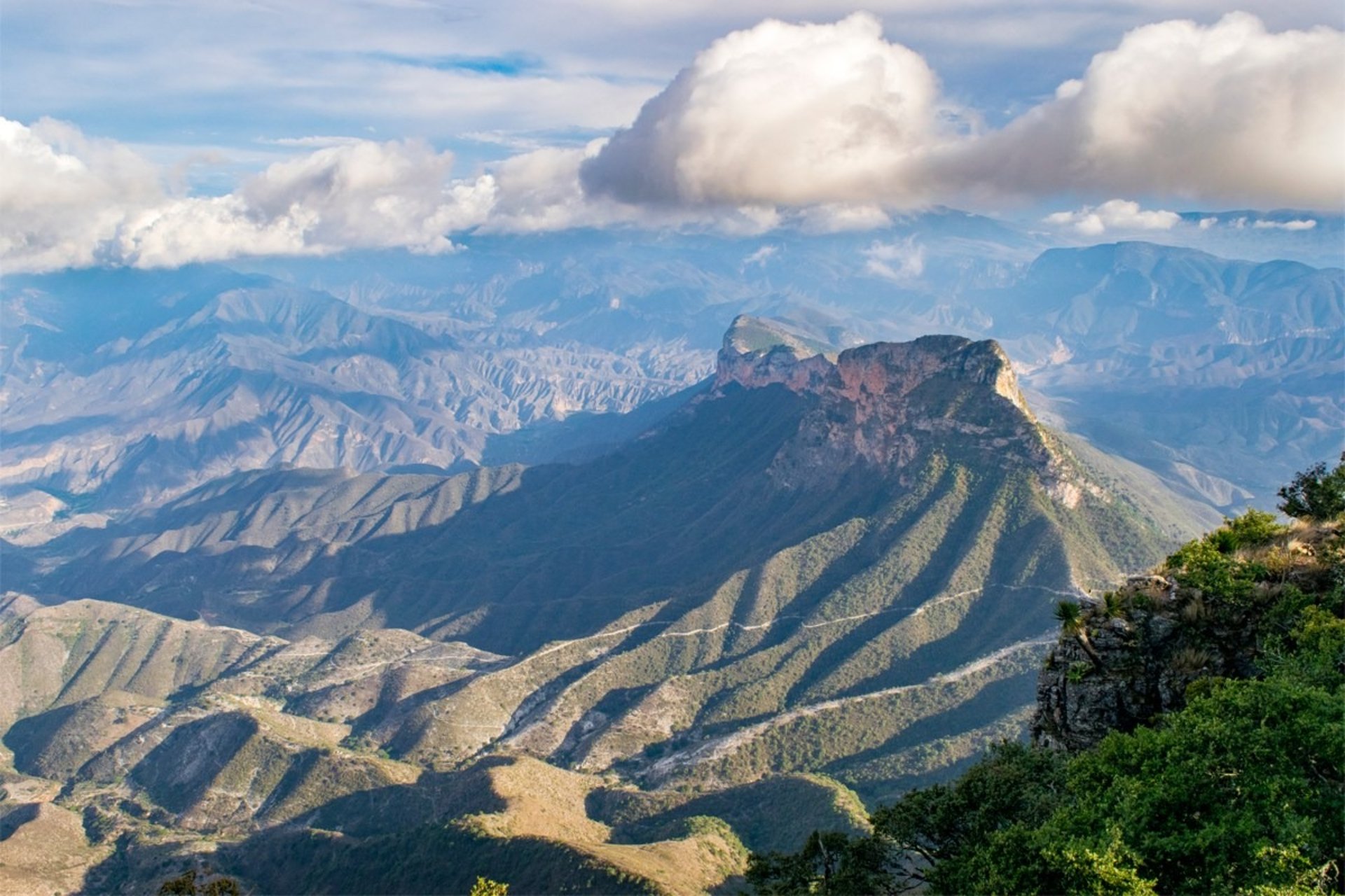 The sun is setting over a mountain range