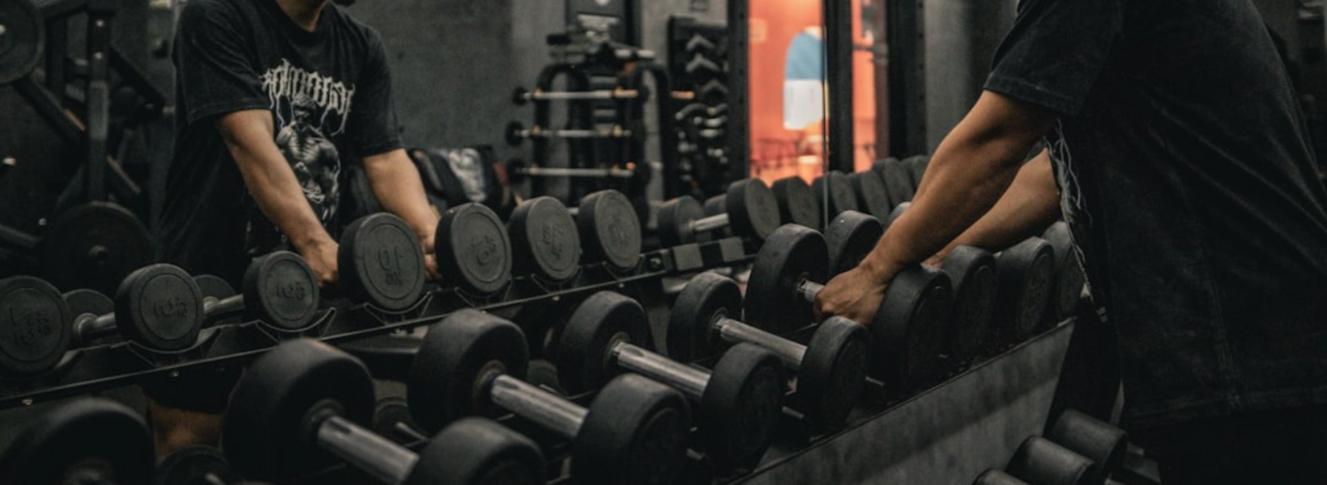 A couple of men working out in a gym