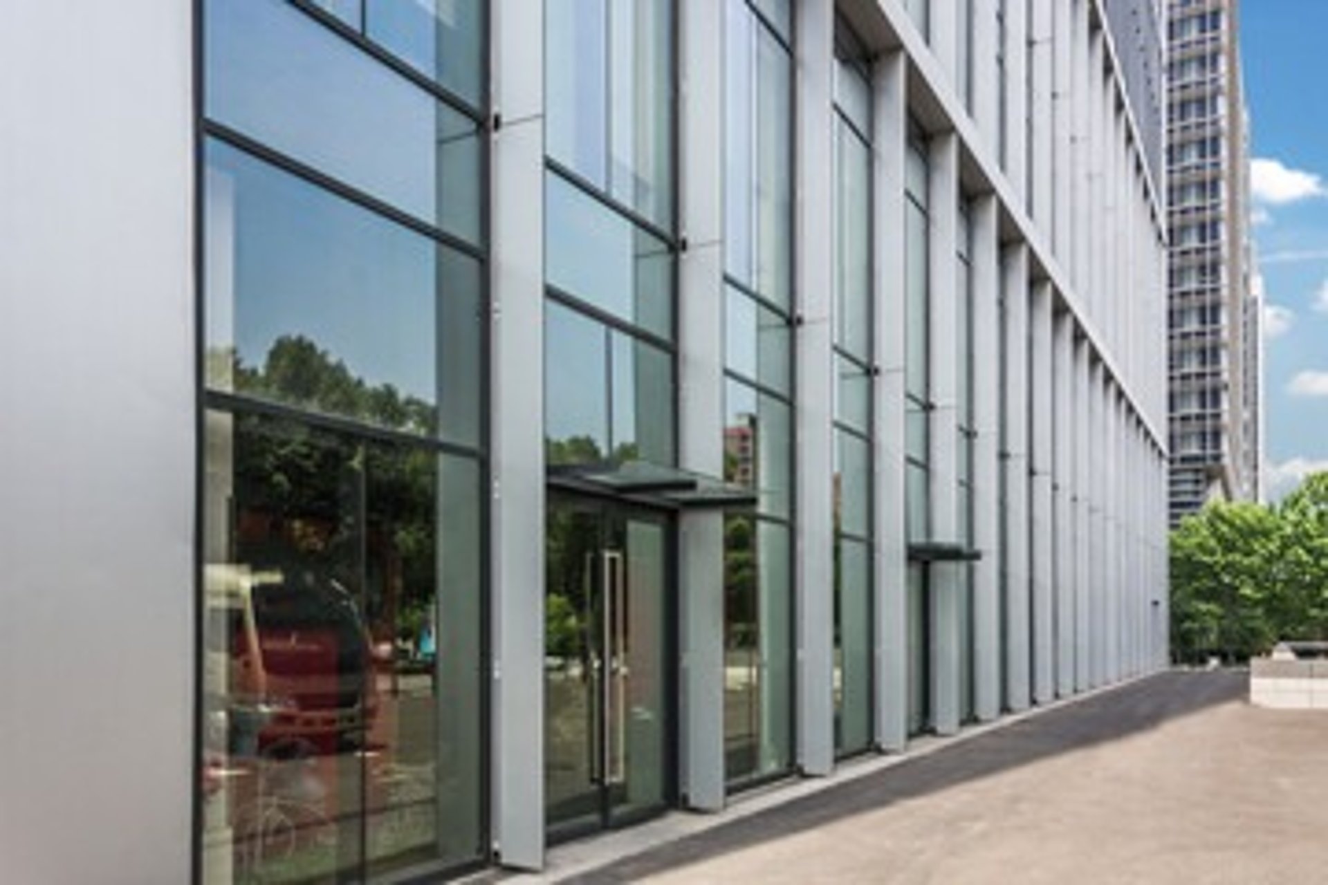 an abstract photo of a curved building with a blue sky in the background