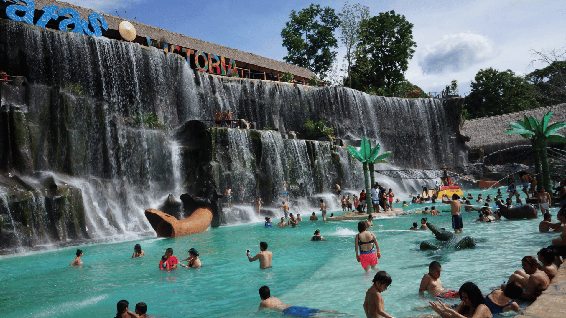 aerial view of city near lake under cloudy sky during daytime