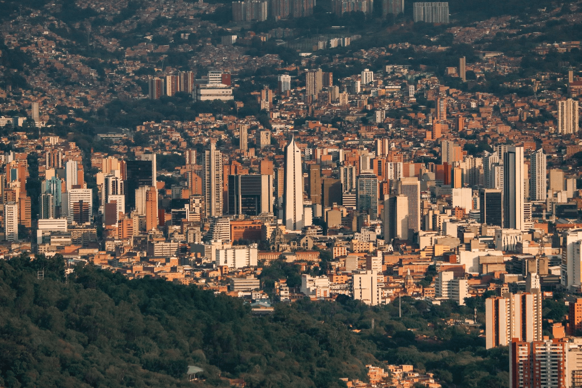 aerial view of city near lake under cloudy sky during daytime