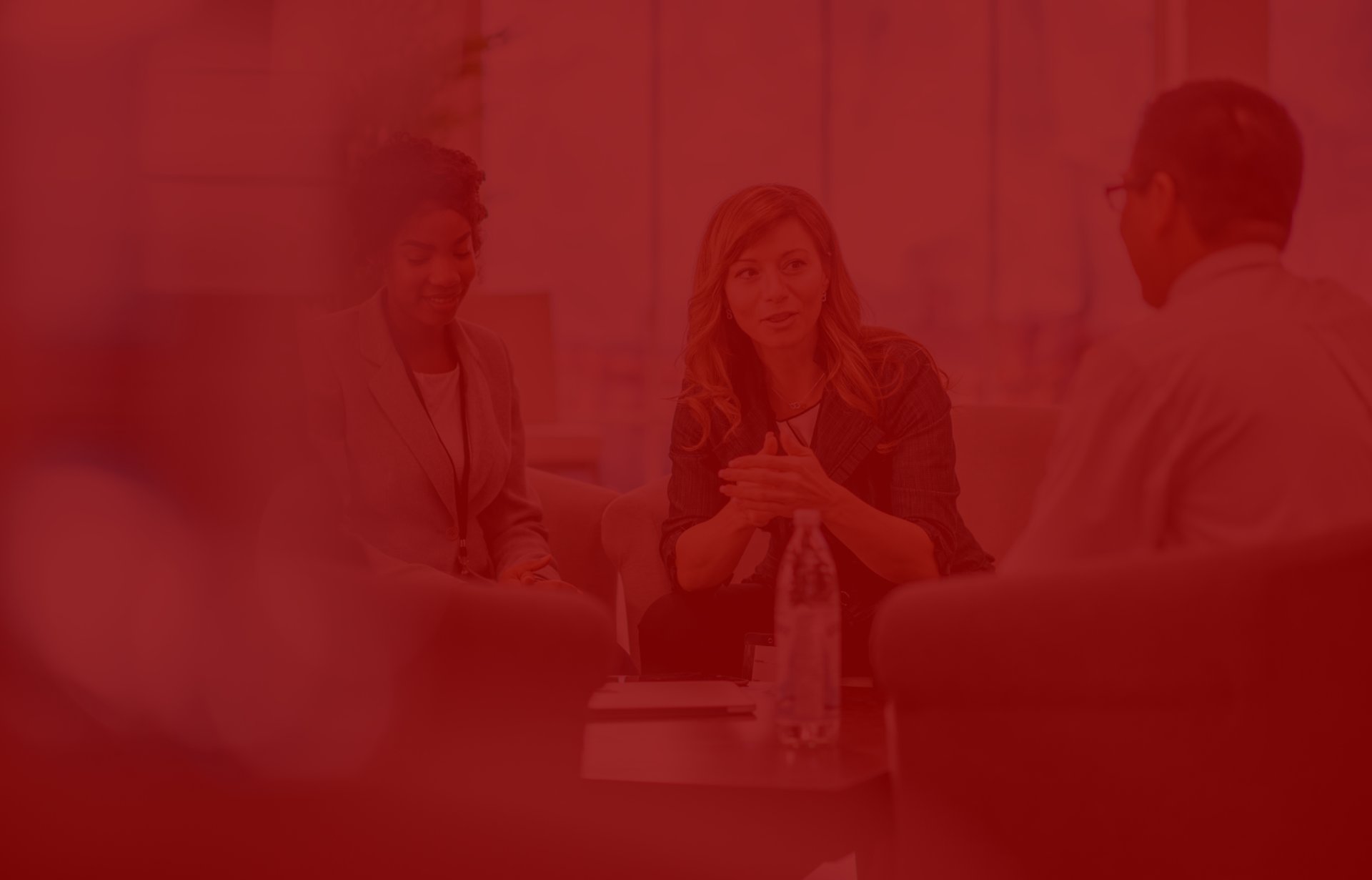 Business meeting around a table on sofas.