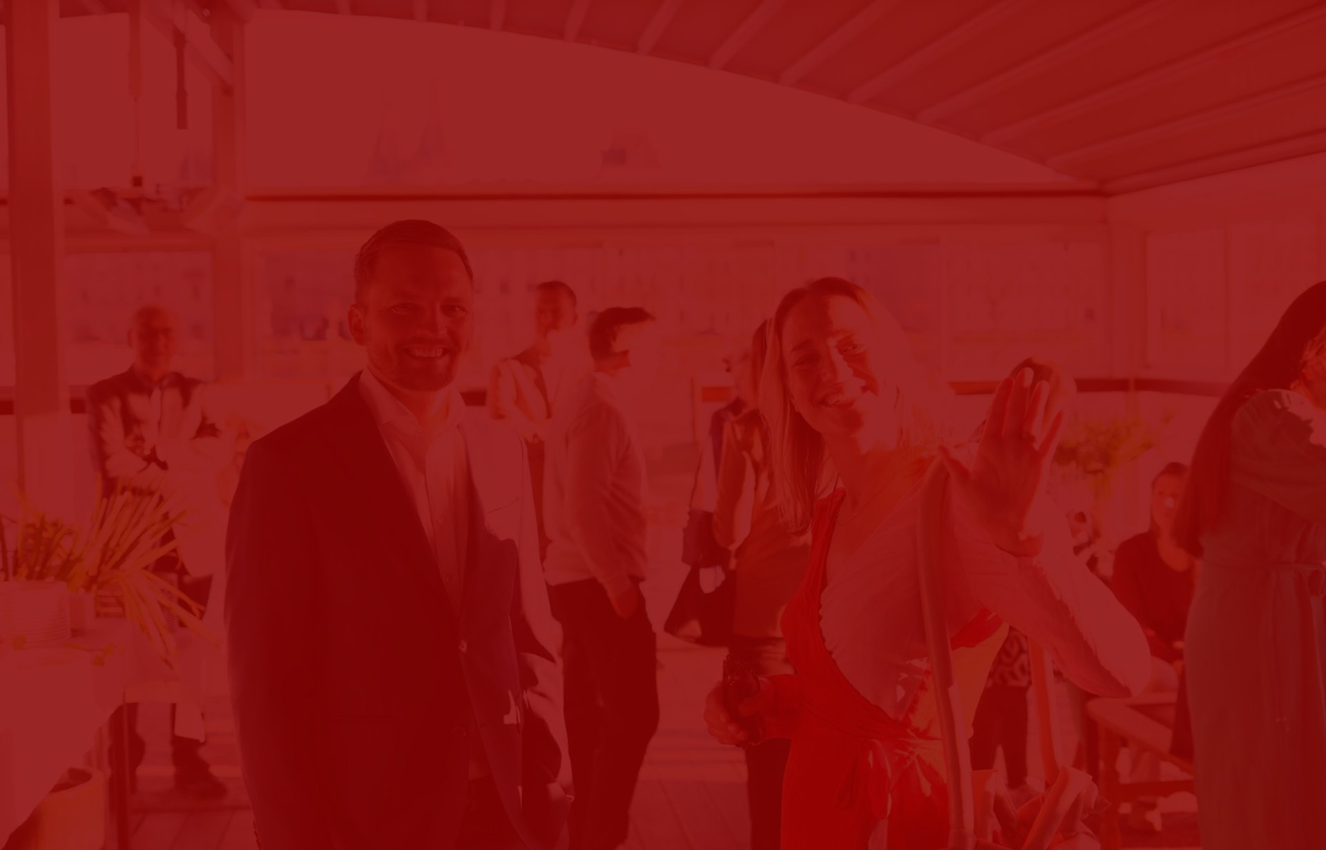 People mingling at an outdoor event with food spread.