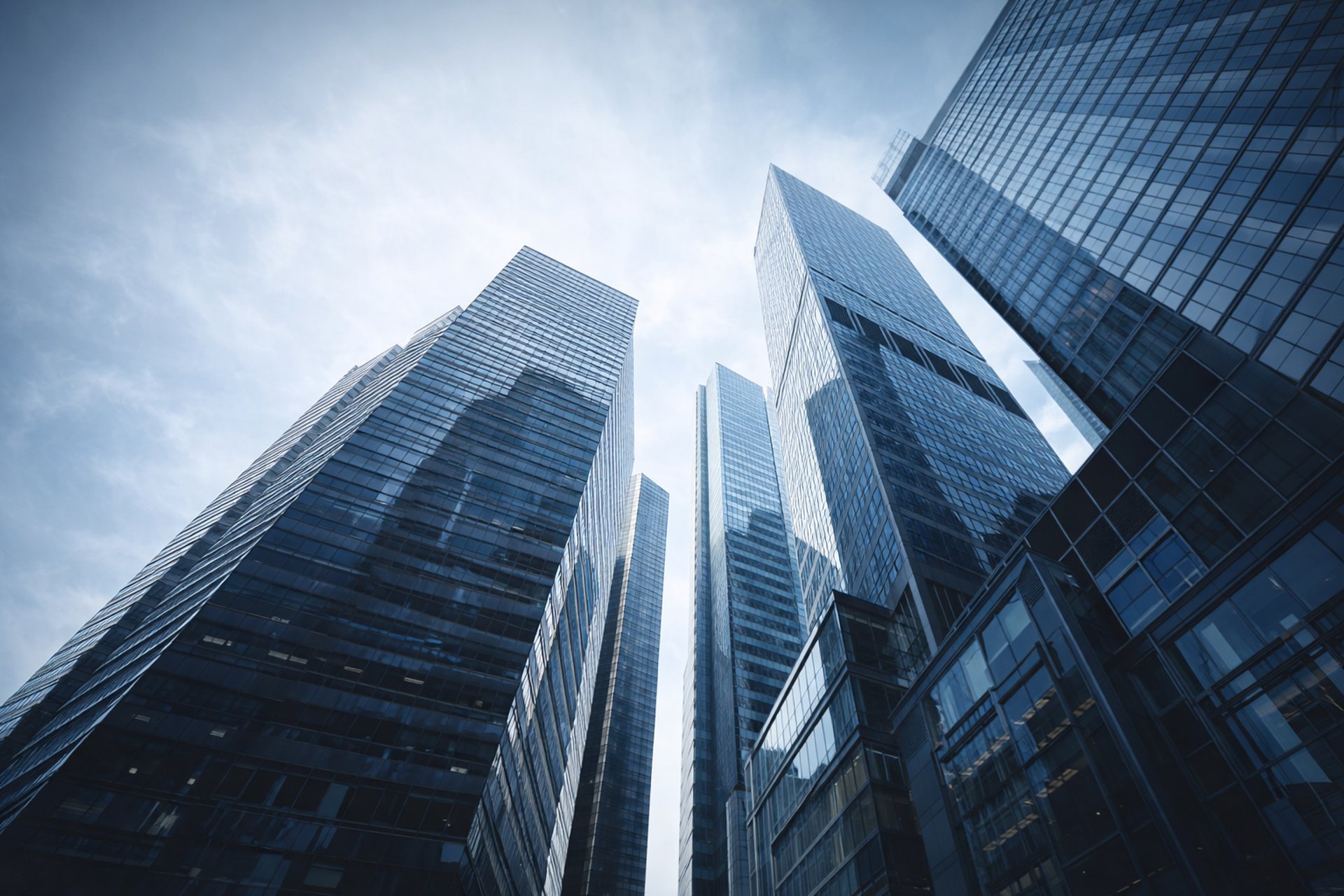 an abstract photo of a curved building with a blue sky in the background