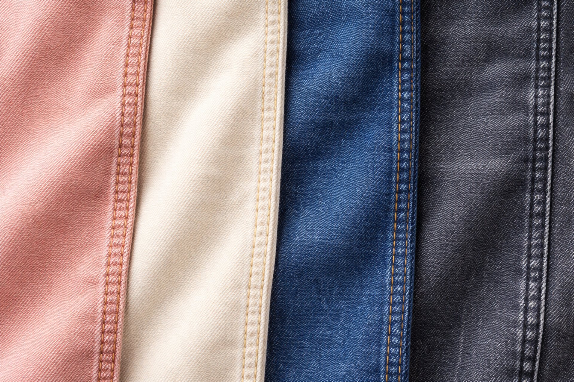 photo of three men jumping on ground near bare trees during daytime