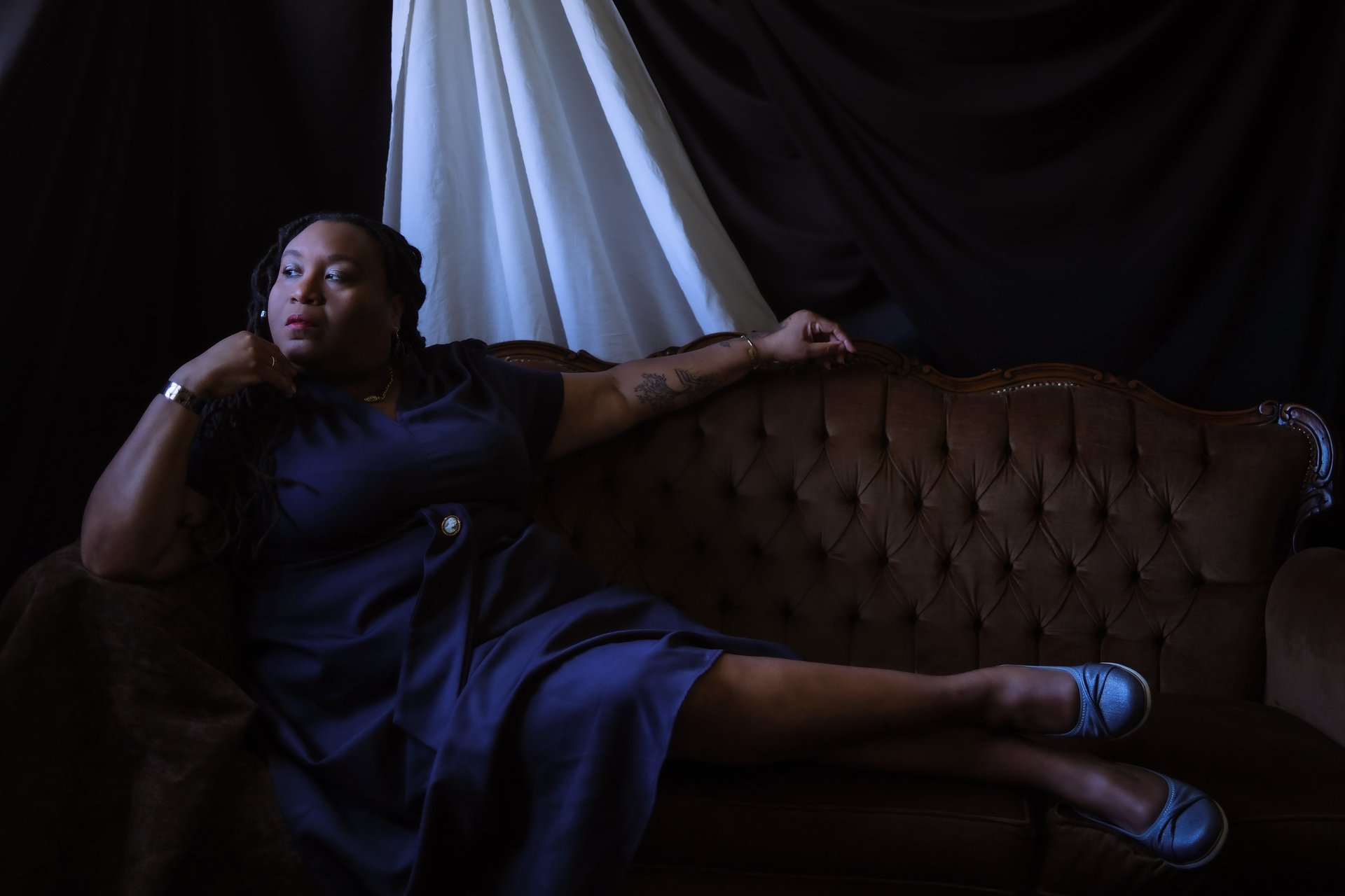 black and brown leather padded tub sofa