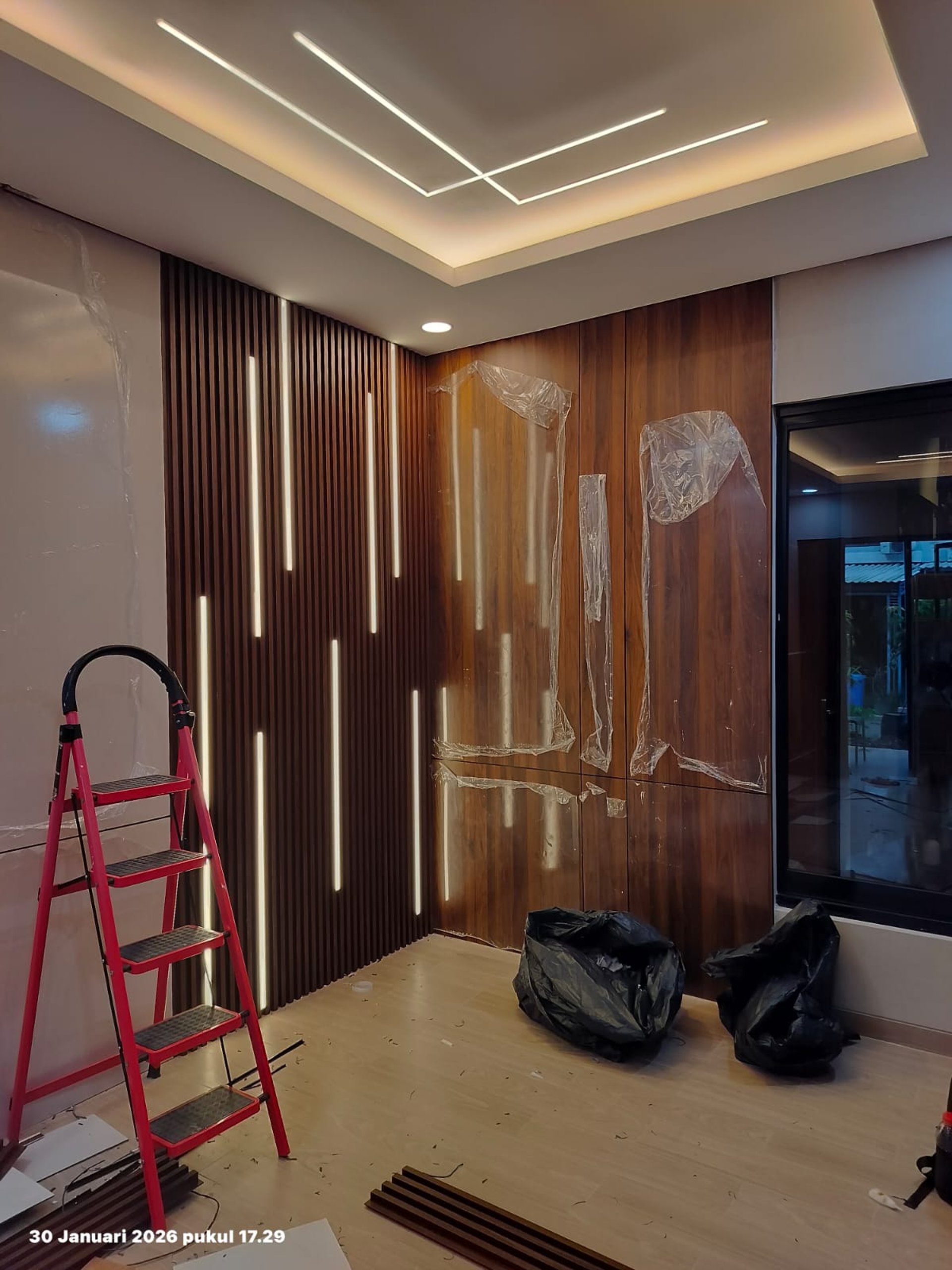 Elegant dining room with plush chairs and modern chandelier.